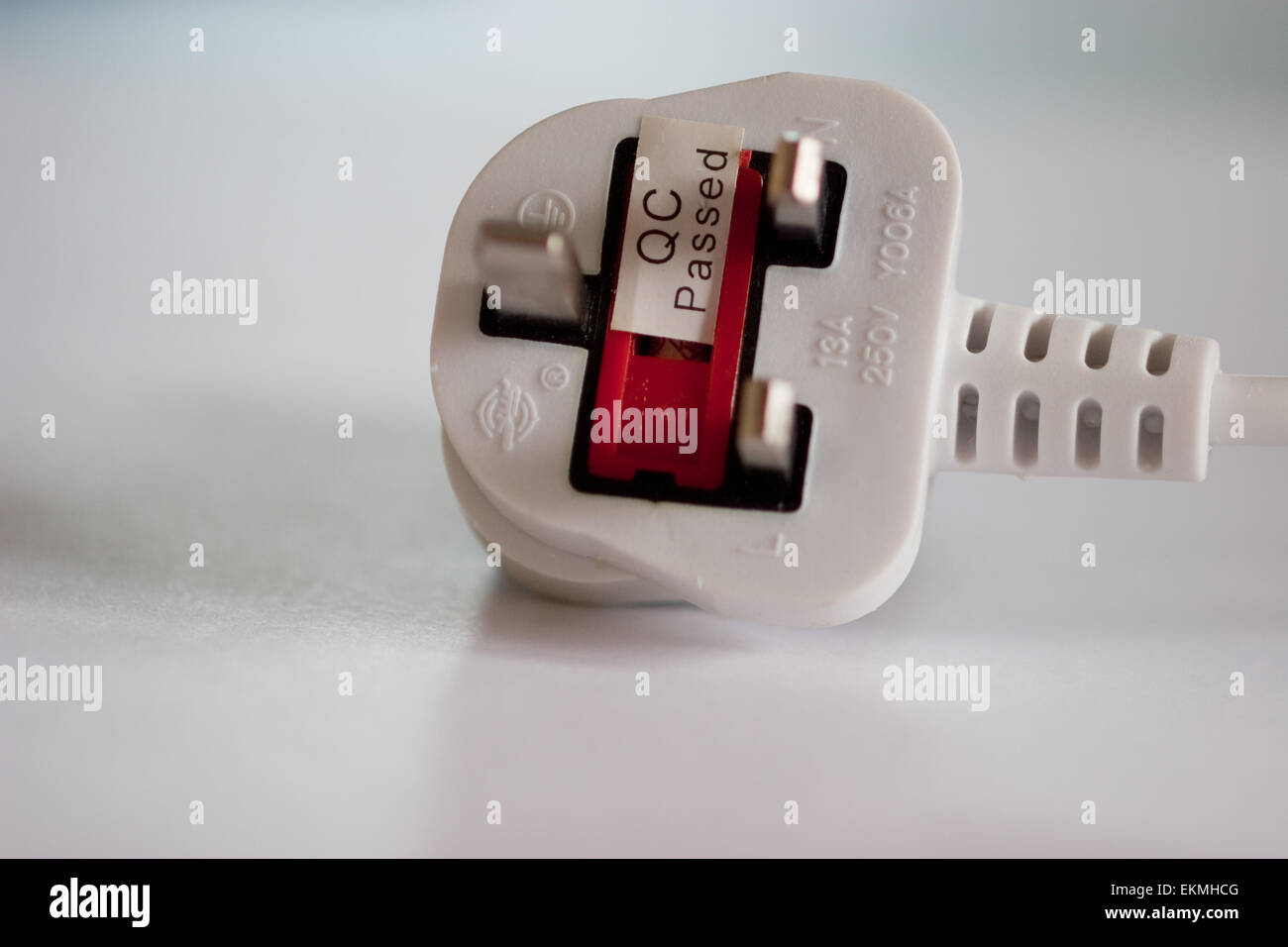 Three pin plug with a QC passed sticker Stock Photo Alamy