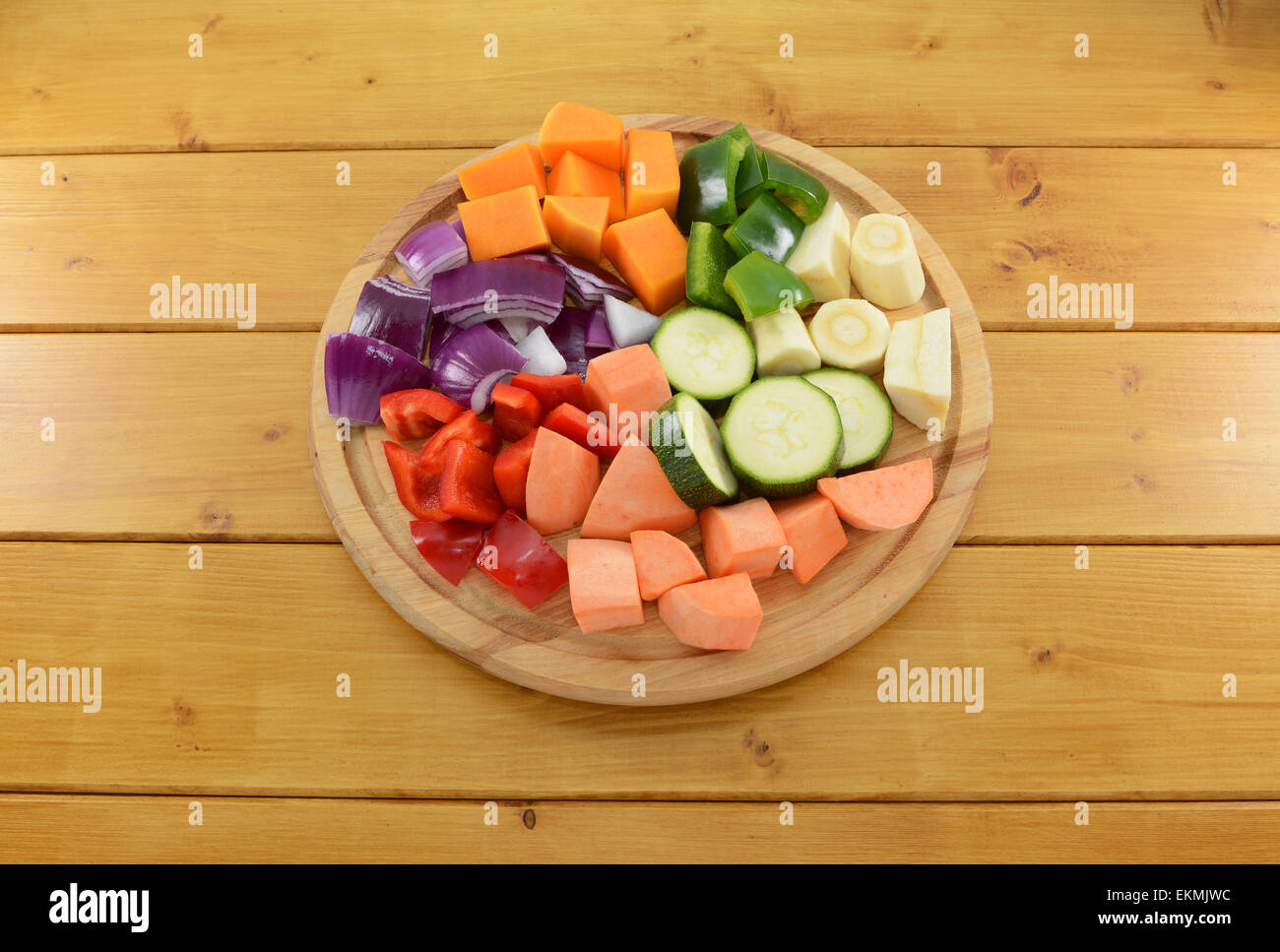 Selection of chopped vegetables on a wooden chopping board Stock Photo