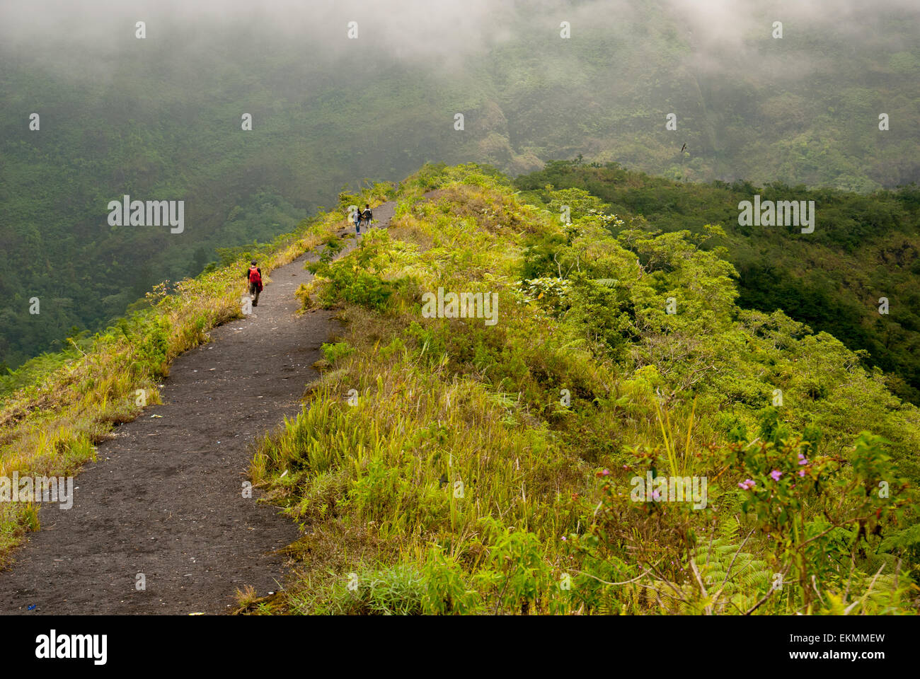 People walk on caldera ridge of Mount Galunggung volcano in Tasikmalaya regency, West Java, Indonesia. Stock Photo