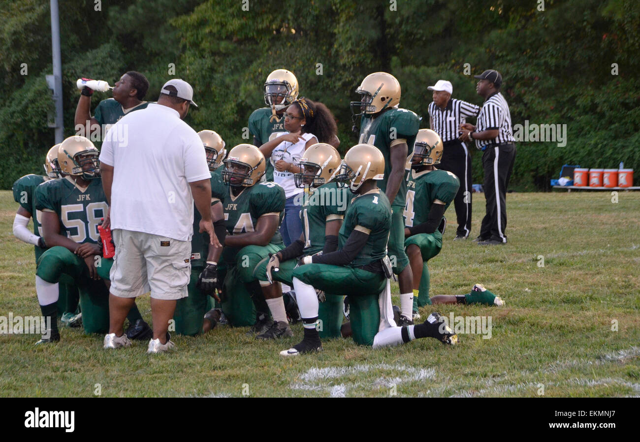 Coach talking to teen football team Stock Photo Alamy