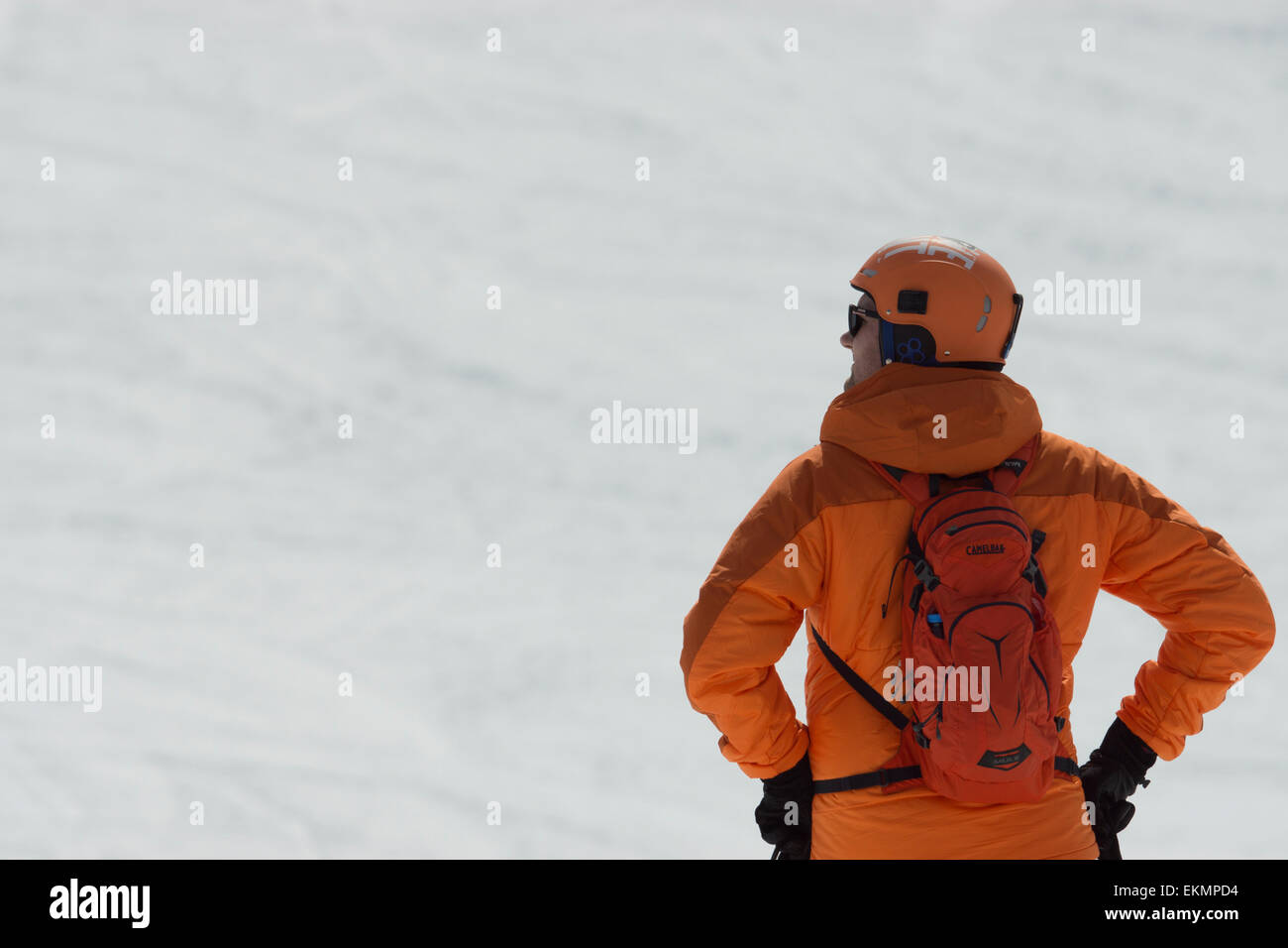 A snowboarder and a skier, enjoying the alps together playing around and admiring the views. Stock Photo