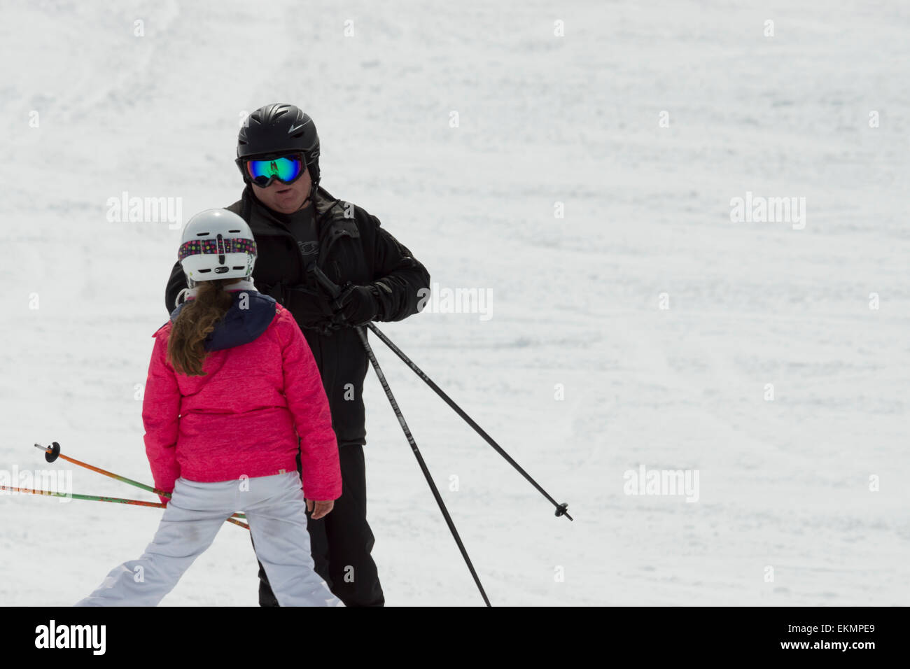 A skiing family trip, in the alps. A father is pointing directions for