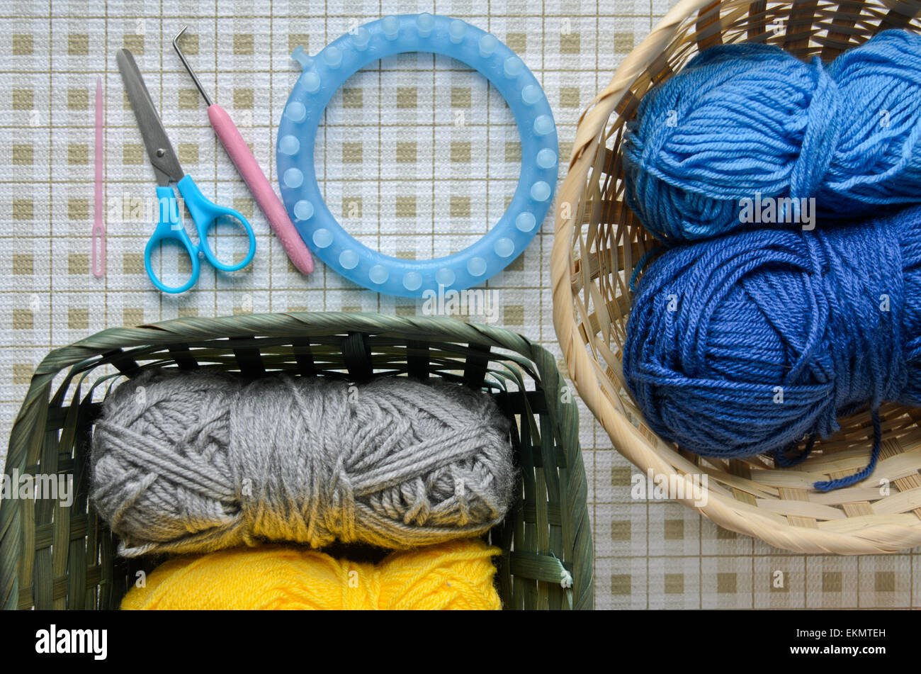 Yarns in baskets and knitting tools Stock Photo