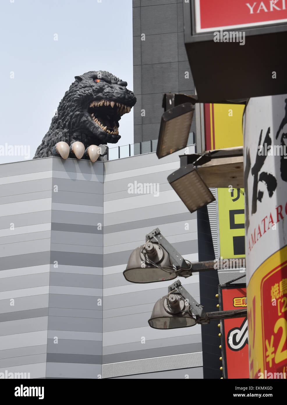 Tokyo, Japan. 12th Apr, 2015. Japan's fire-breathing, building-stomping Godzilla returns to the nation's capital on Sunday, April 12, 2015. The life-size head of the world-renowned fictional monster was unveiled atop a hotel balcony some 52 meters above ground in a new commercial complex in Tokyo's Shinjuku district. © Natsuki Sakai/AFLO/Alamy Live News Stock Photo