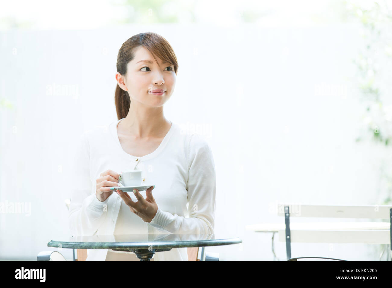 Attractive young girl having coffee outside Stock Photo
