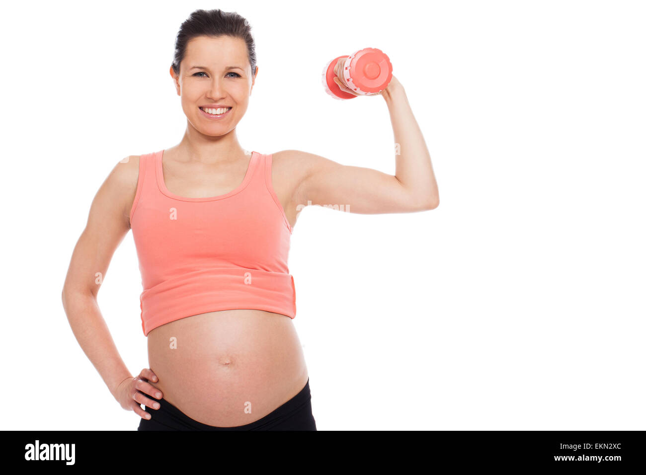 Pregnant woman working out with dumbbells Stock Photo