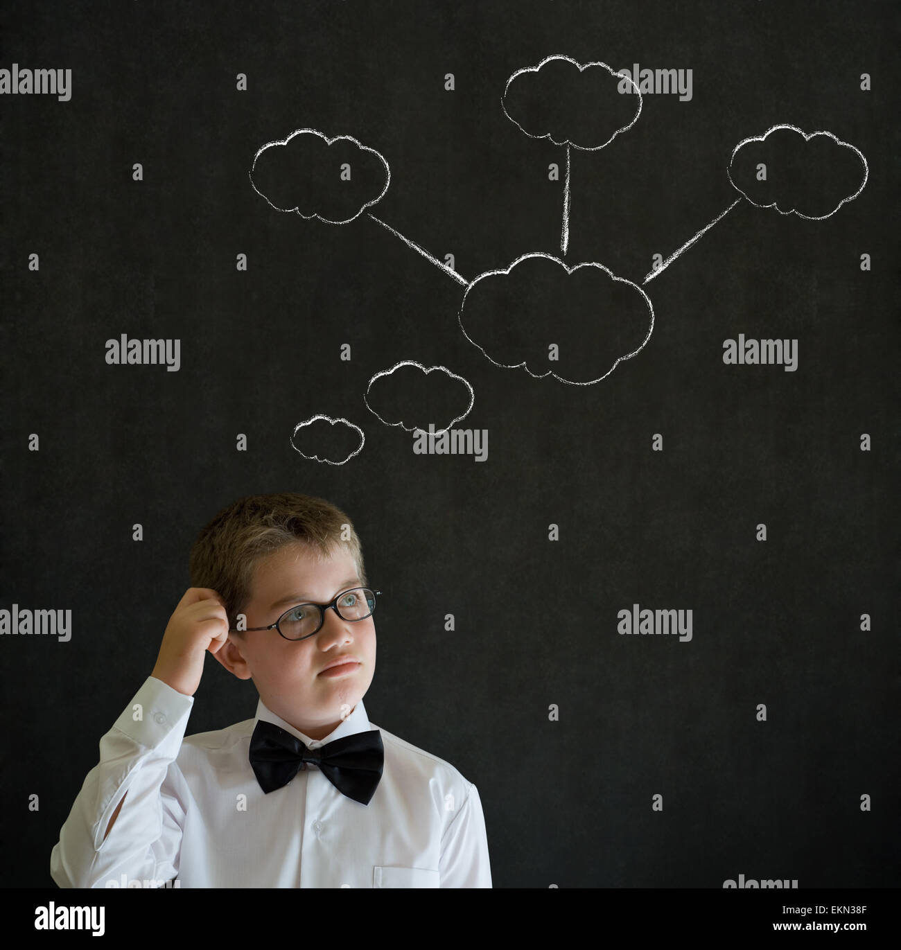 Scratching head thinking boy dressed as business man with strategy thought chalk clouds Stock Photo
