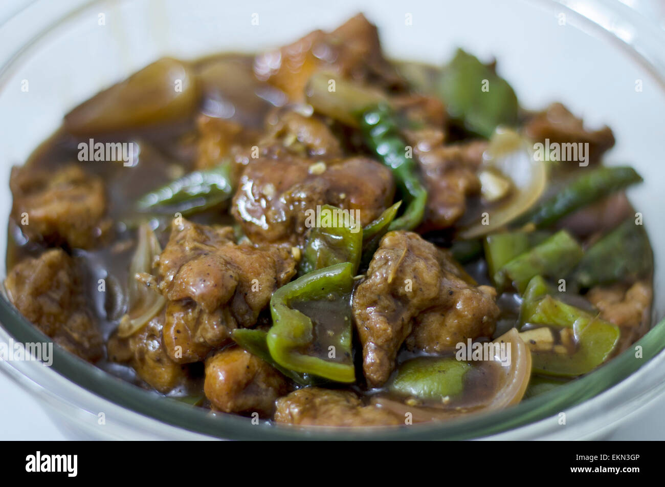 Spicy Chilli chicken served in a bowl Stock Photo