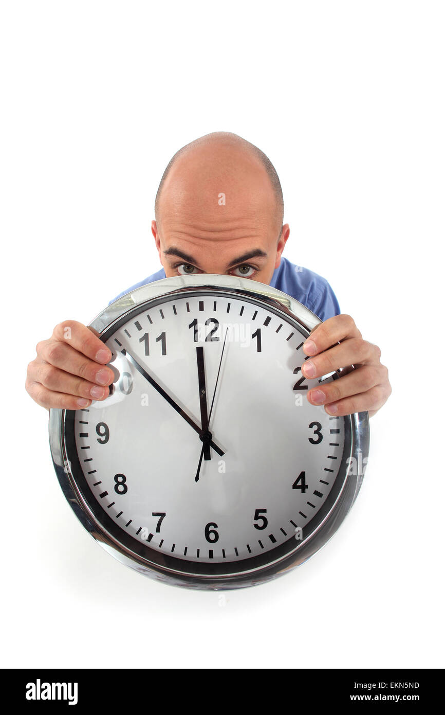 Covering his face with clock Stock Photo