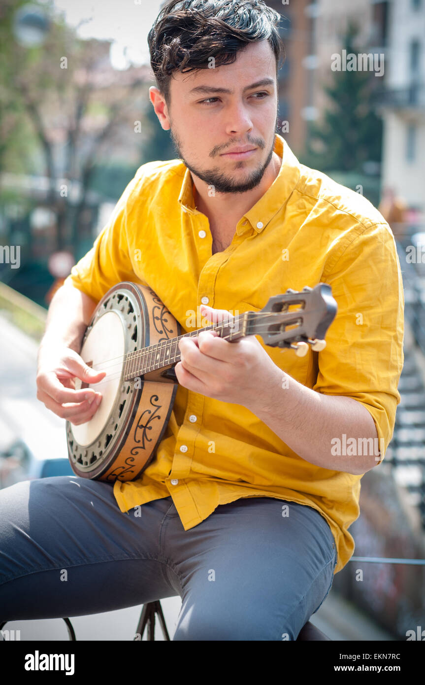 hipster young man playing banjo Stock Photo
