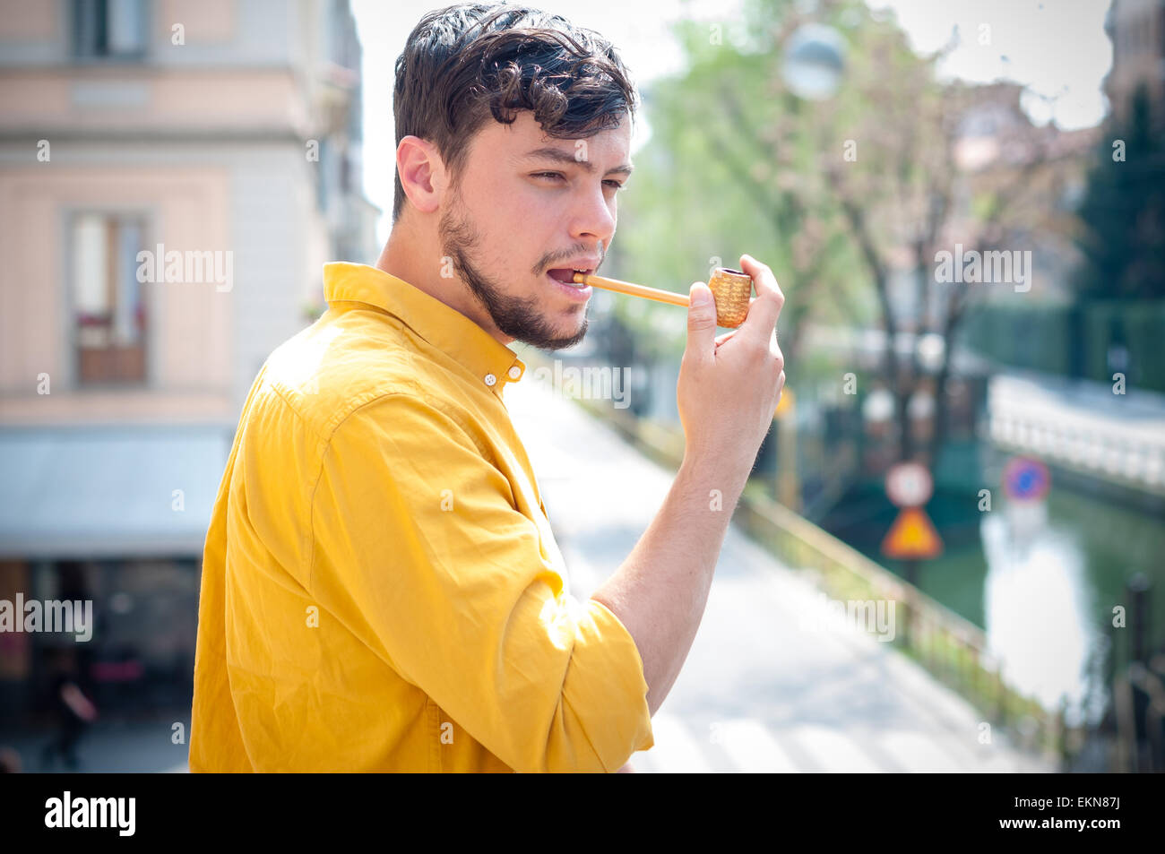 young man smoking pipe Stock Photo