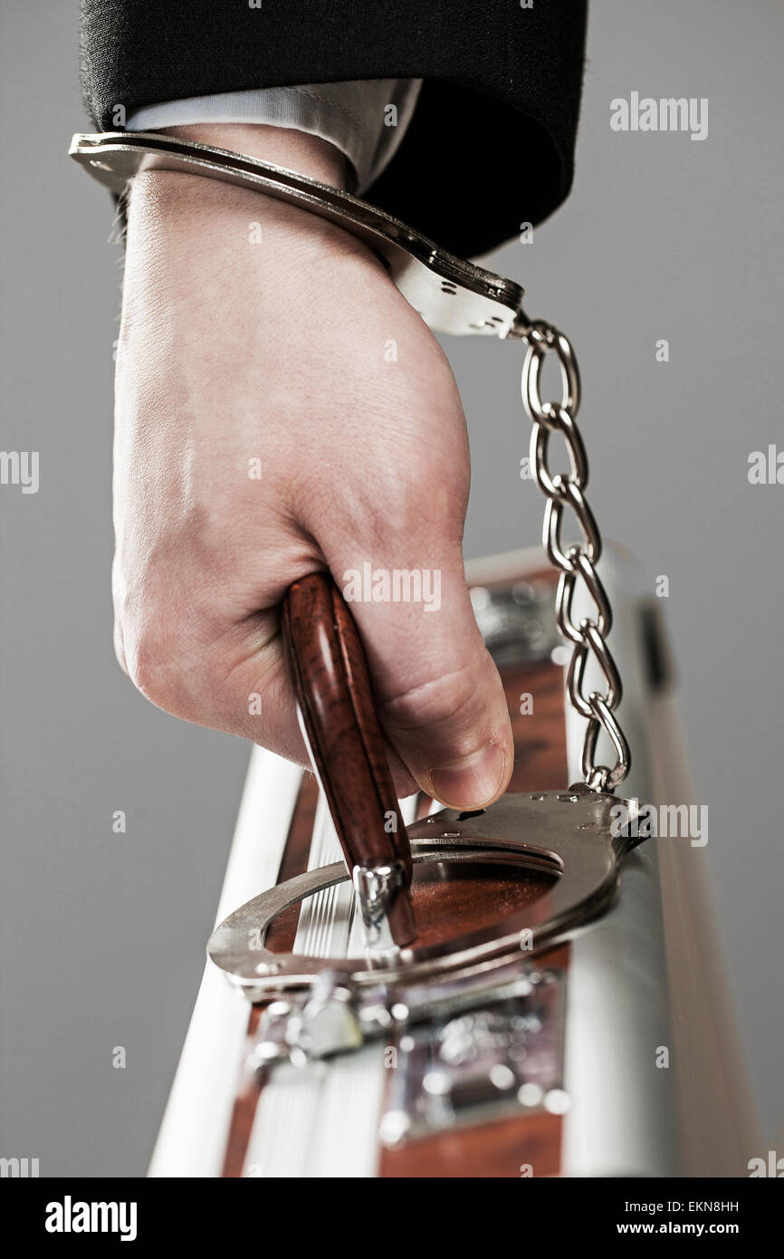 Case attached to hand with handcuffs Stock Photo Alamy