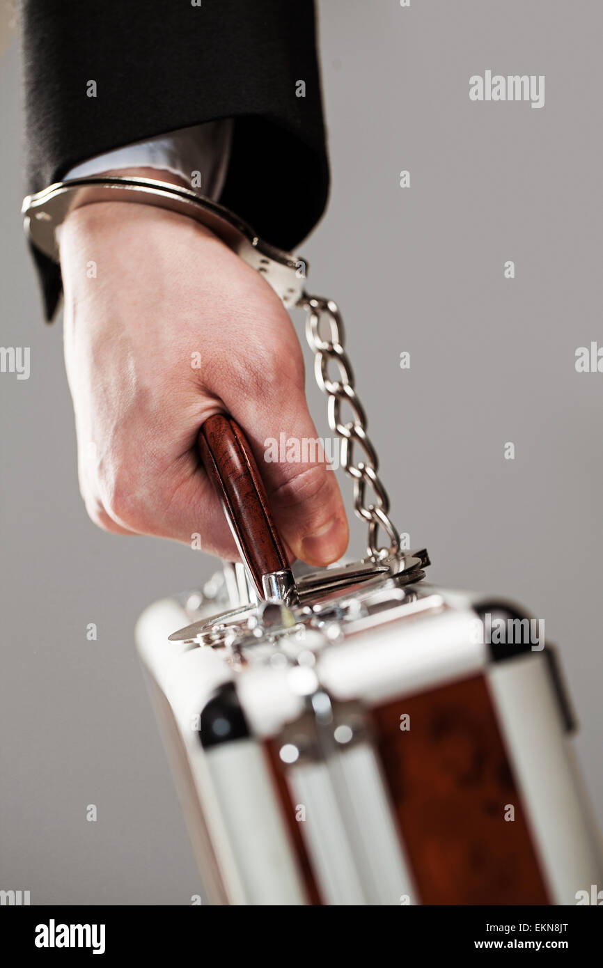 Case attached to hand with handcuffs Stock Photo Alamy