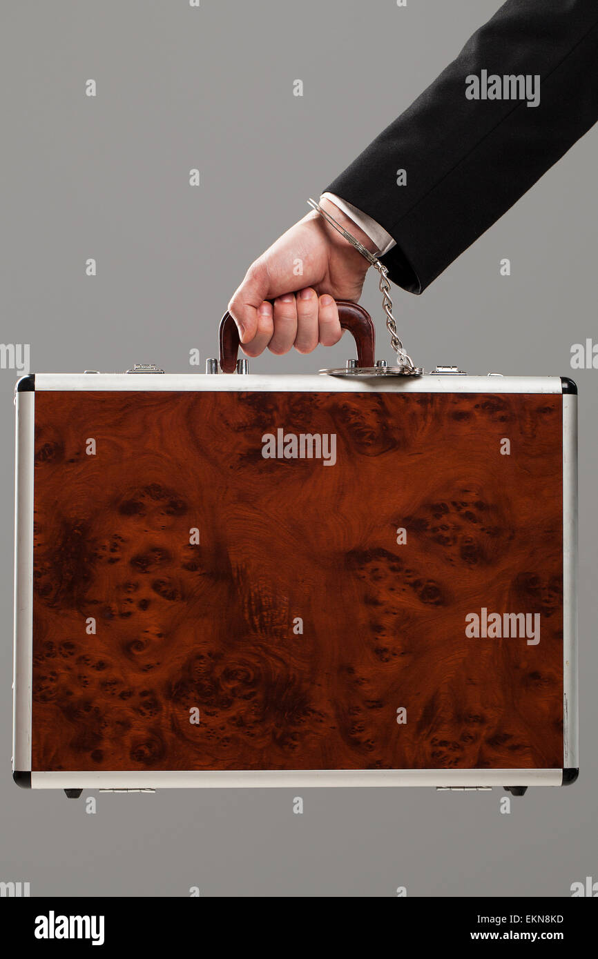 Case attached to hand with handcuffs Stock Photo Alamy
