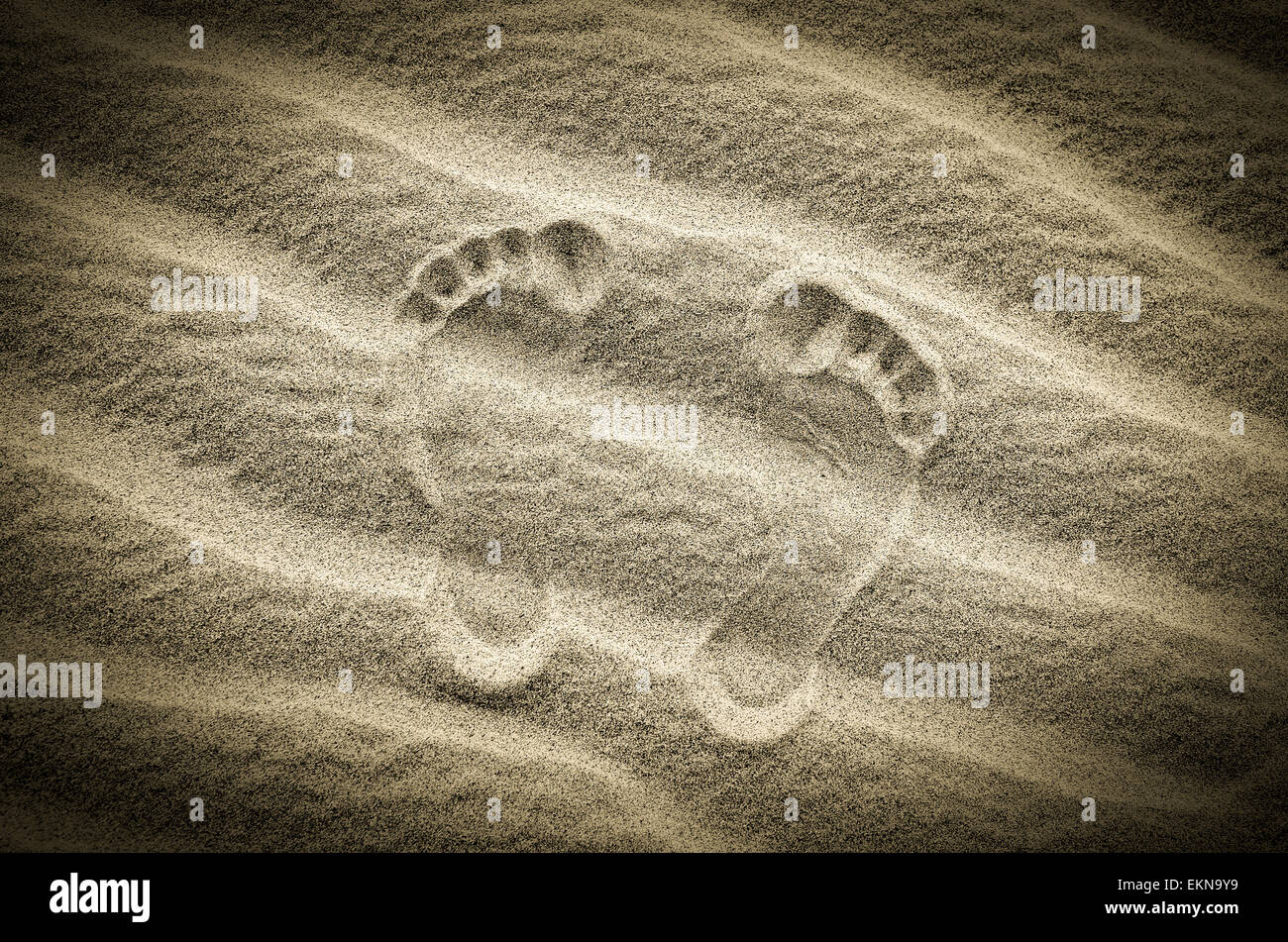 Two footprints in sand on the desert beach Stock Photo - Alamy