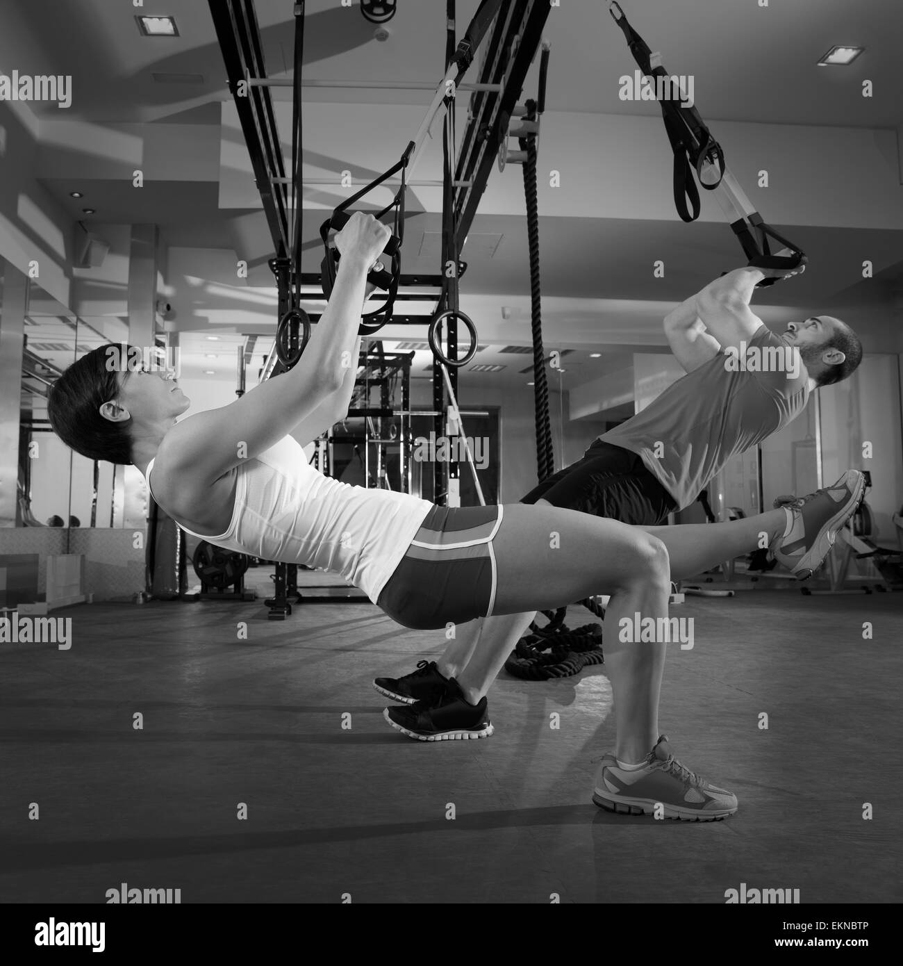 Fitness TRX training exercises at gym woman and man Stock Photo