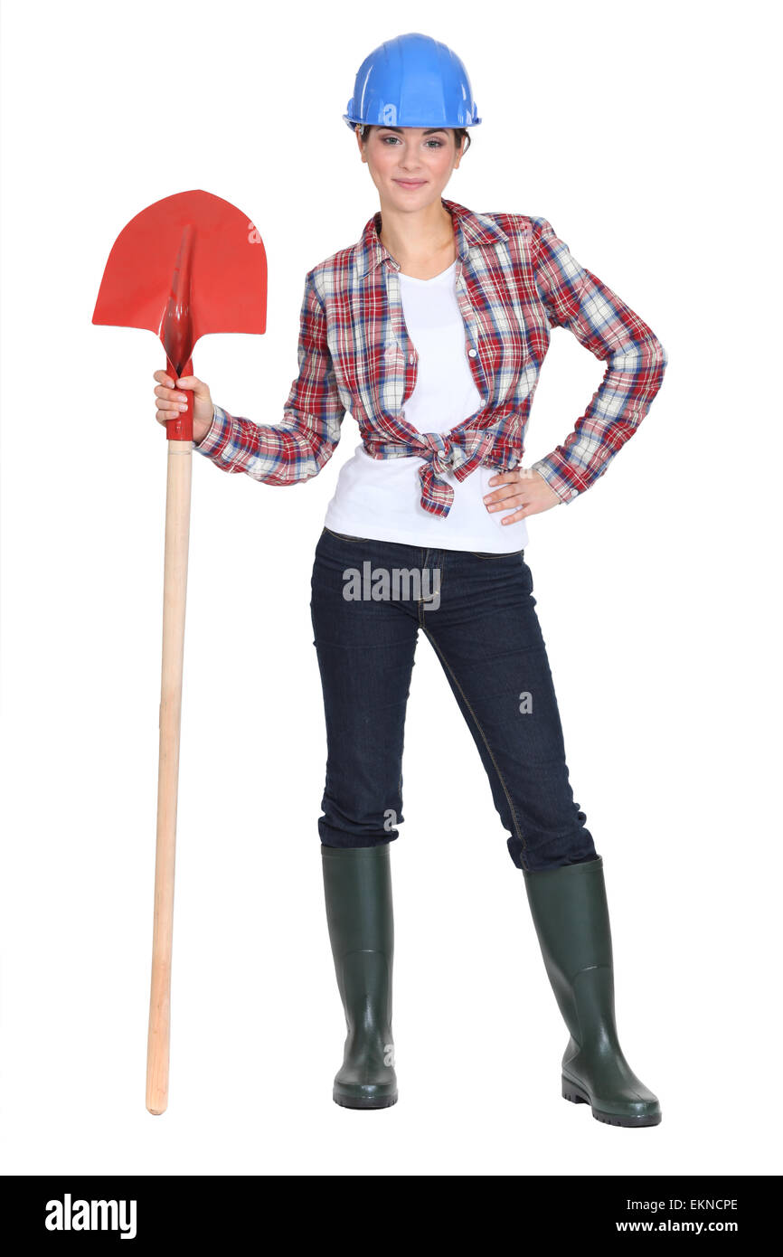 Woman stood with shovel Stock Photo