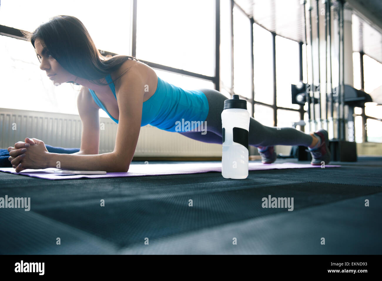 Young fit woman working out on yoga mat at gym Stock Photo - Alamy