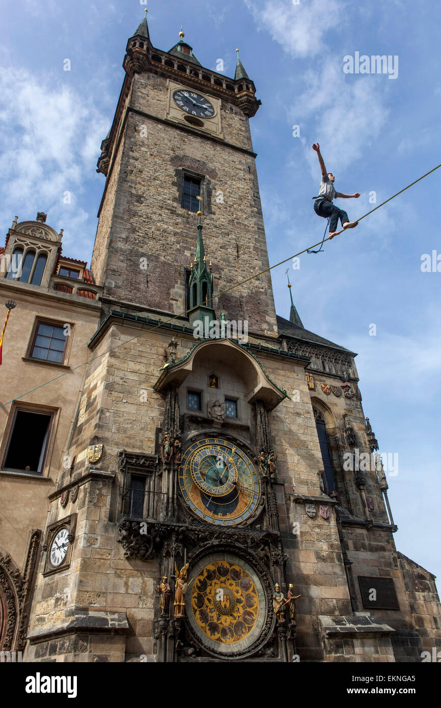 Tightrope walker on the lane in front of the Astronomical Clock, Town Hall Tower Prague Czech Republic Stock Photo
