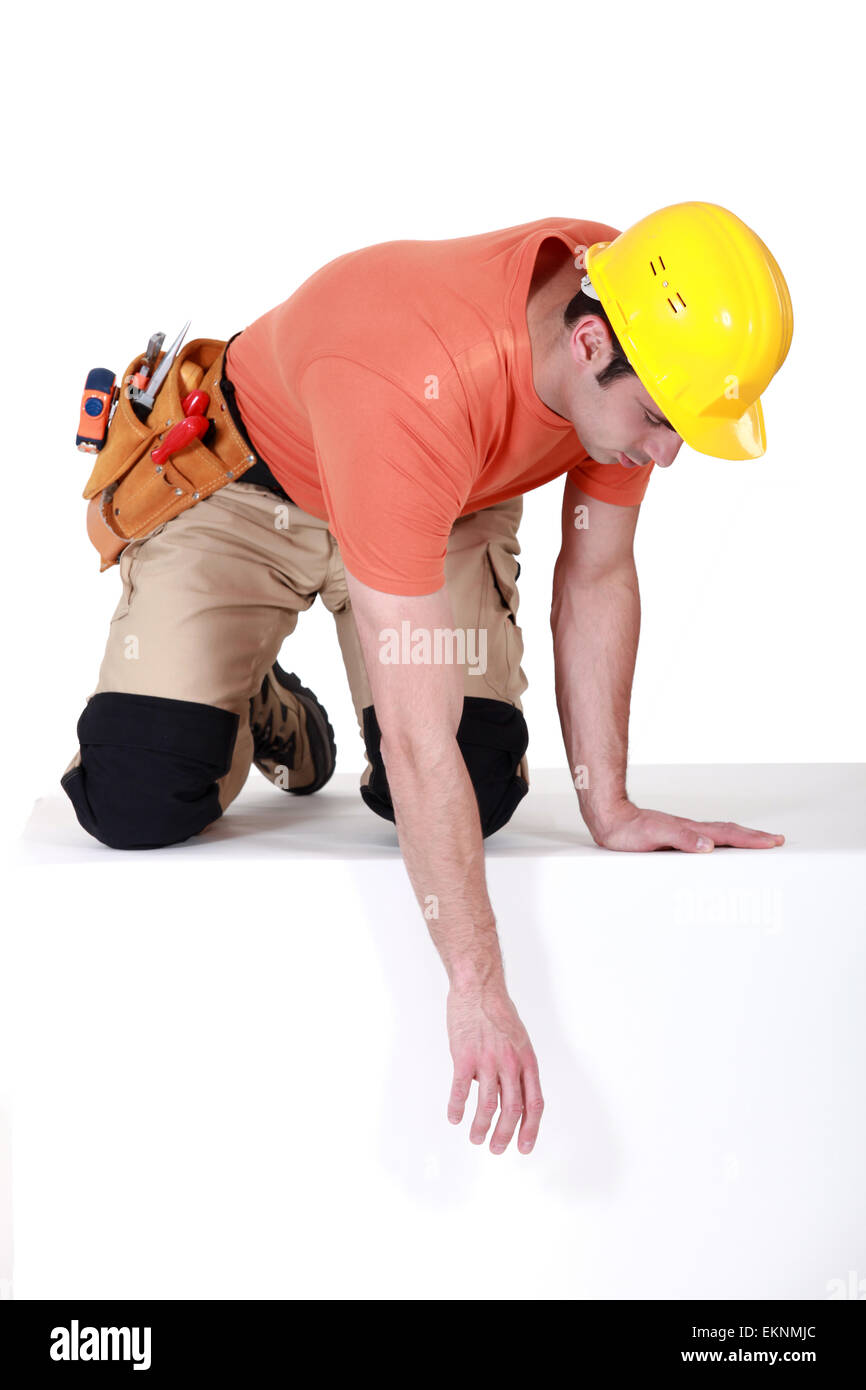 Construction worker reaching down Stock Photo Alamy
