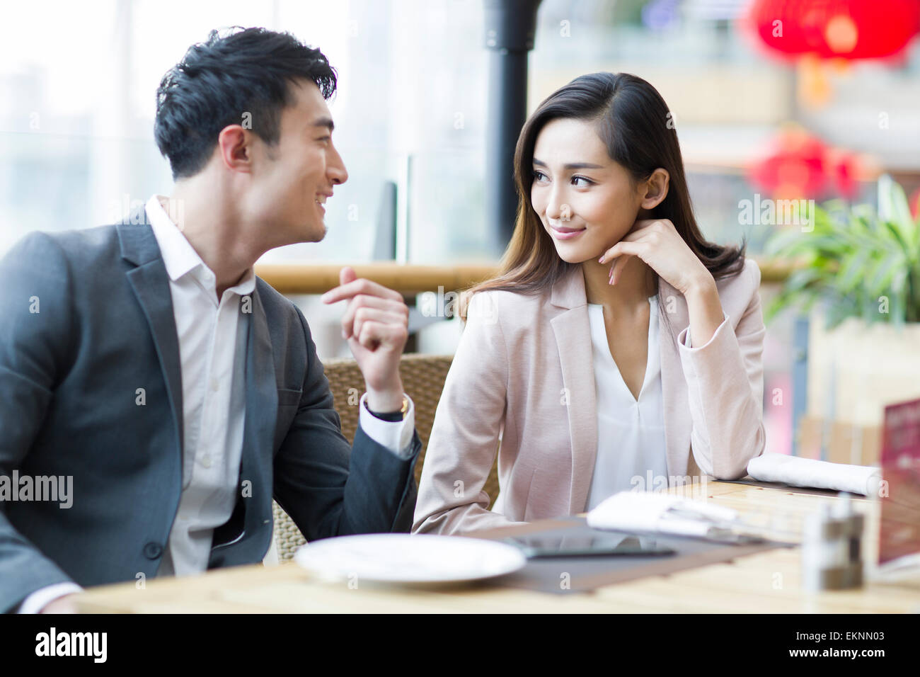 Young couple sitting in restaurant Stock Photo Alamy