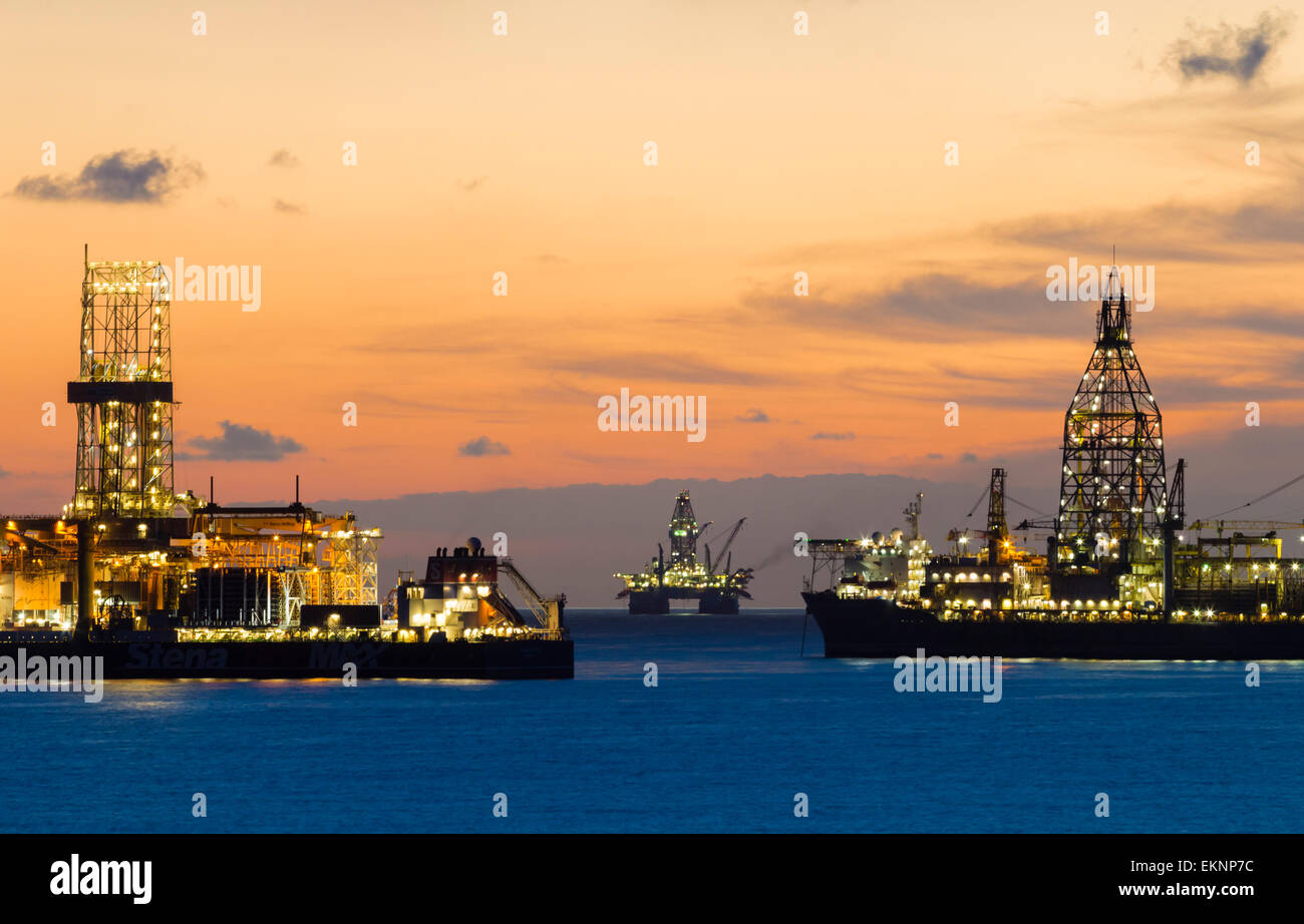 Drill ships/oil rigs at sunrise in Atlantic Ocean. Stock Photo