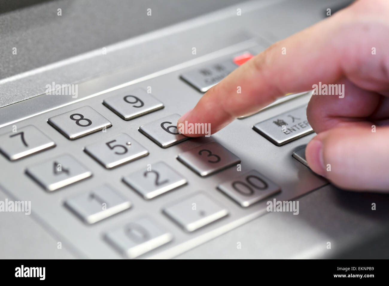Human hand enter atm banking cash machine pin code Stock Photo