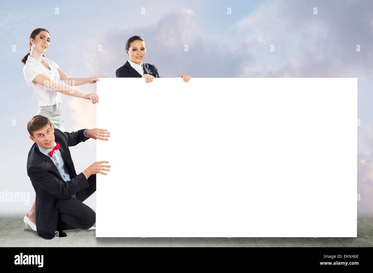 small group of people holding a blank banner Stock Photo - Alamy