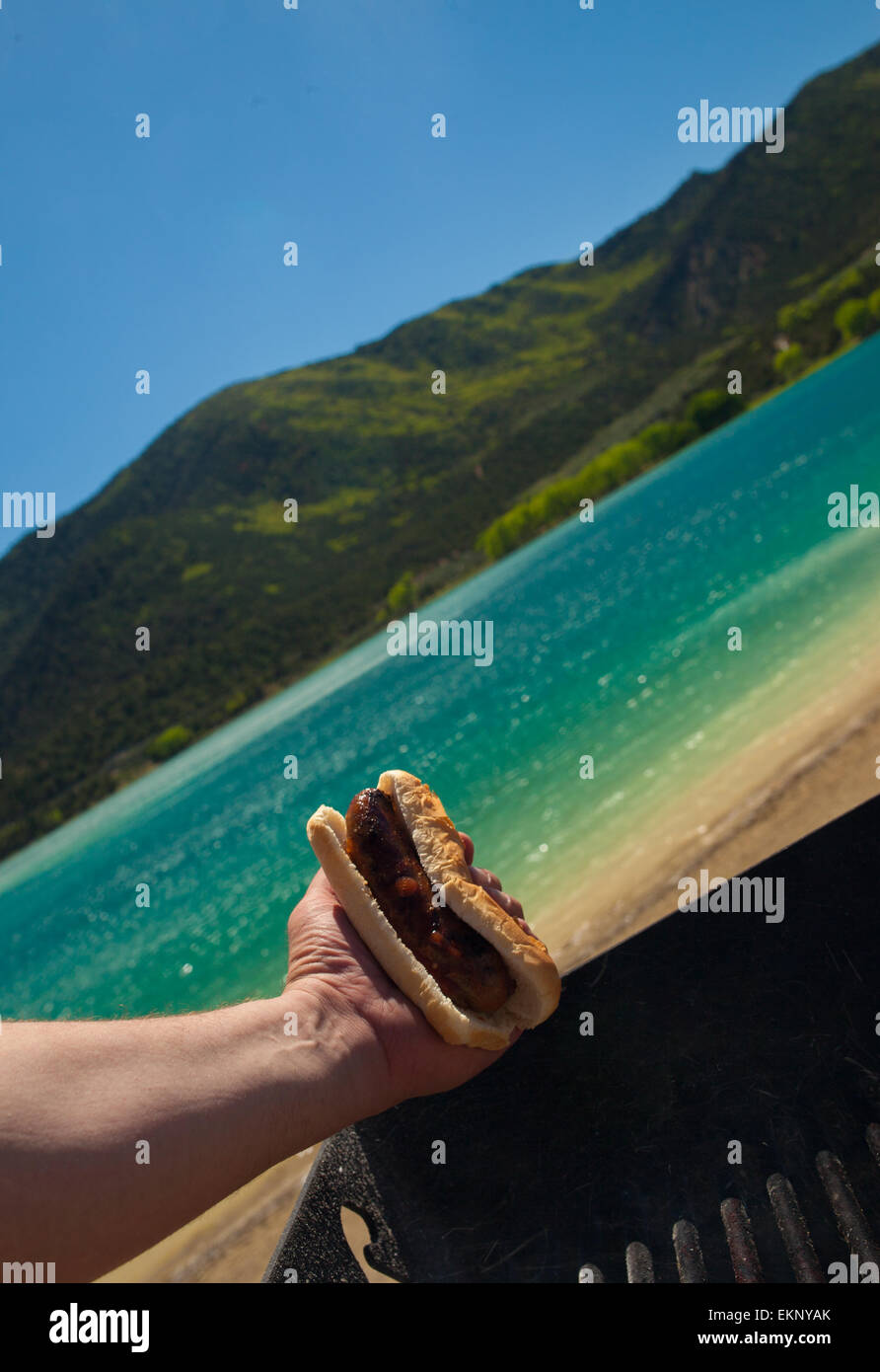 Man holding a cooked sausage roll Stock Photo