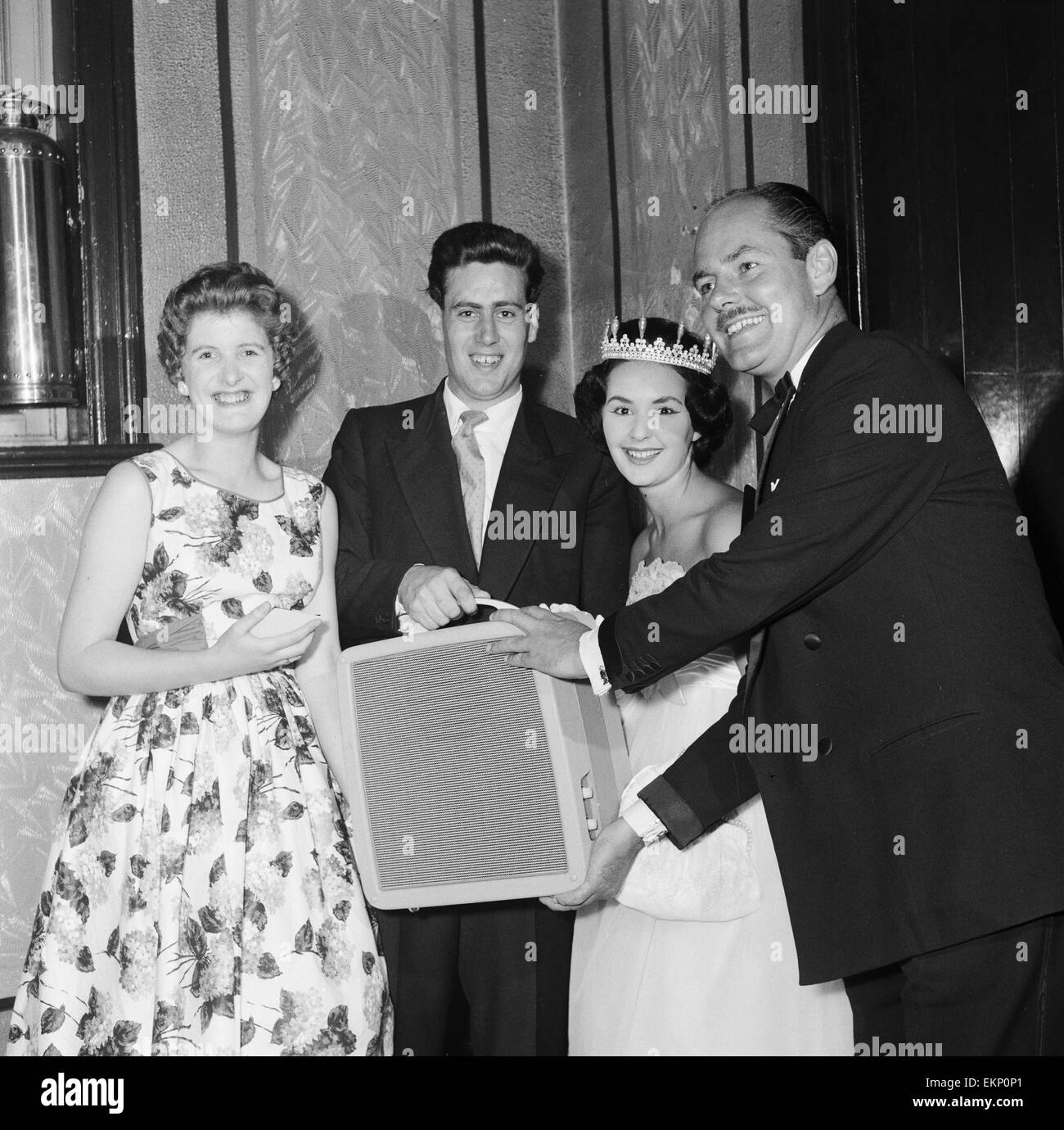 Maurice Hume and Maureen Sutton, aged 20 from Darlington, who have been engaged for three weeks, receive a prize of a record player from Peter Haigh during Blackpool week. 4th August 1959. *** Local Caption *** Maureen Hume Stock Photo