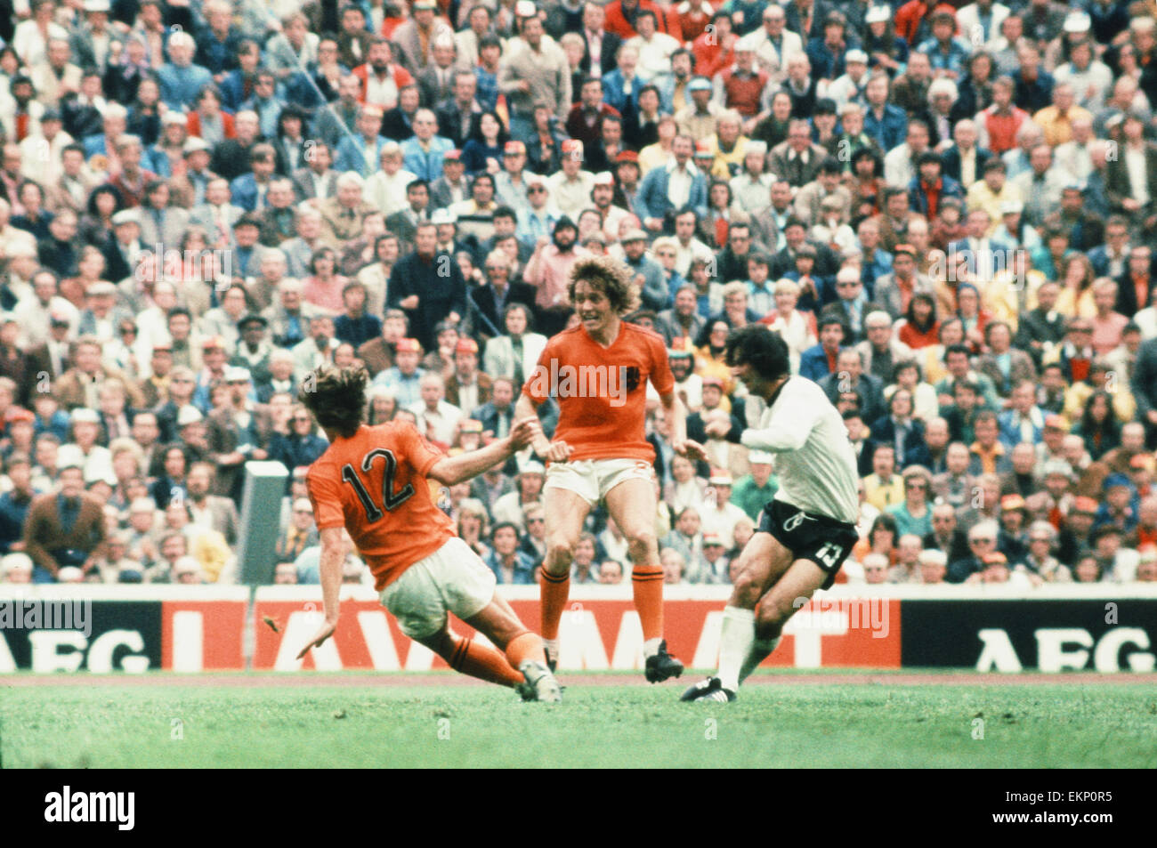 1974 World Cup Final at the Olympic Stadium in Munich. West Germany 2 v Holland 1. Gerd Muller on the turn beats beats Ruud Krol (12) and Arie Haan to score the winning goal. 7th July 1974. Stock Photo