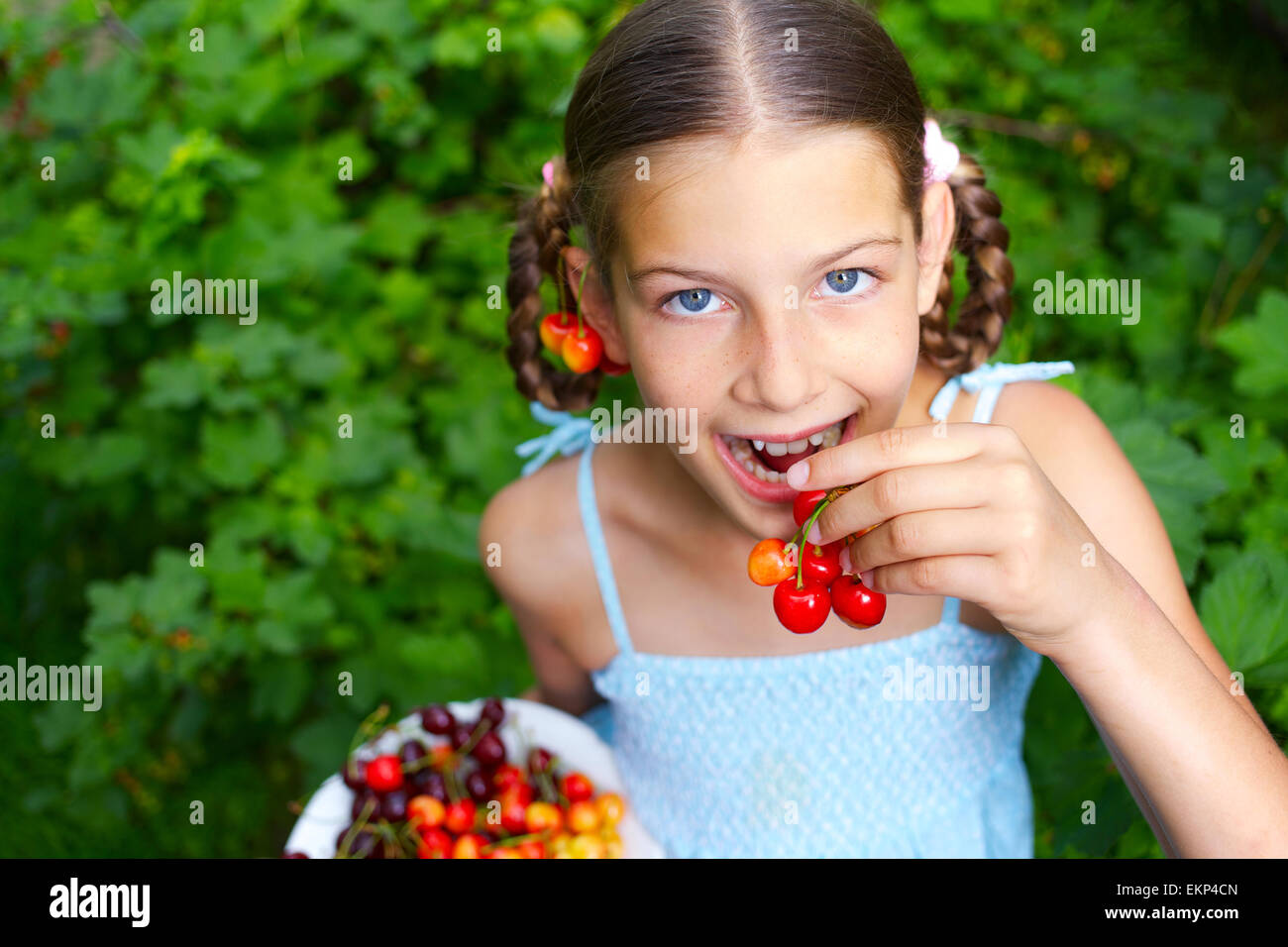 Girl eating cherries Stock Photo Alamy