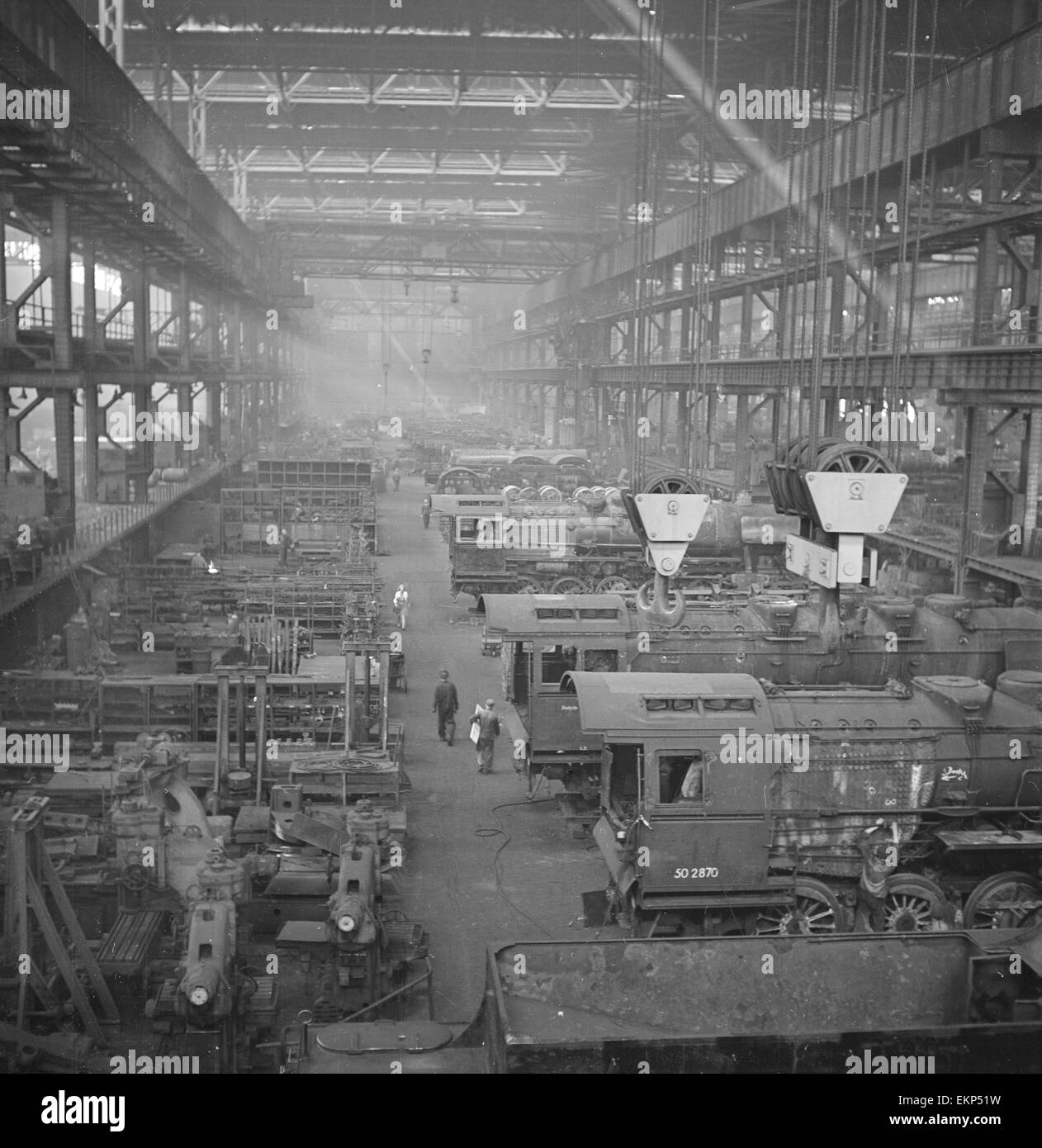 The main workshop at the Lowa Montages Fabrik Steam Locomotive repair facility in Essen, Germany. The factory formerly owned by Krupps employs 1,500 men and during the war this factory made tanks. Since June 1945 the factory has worked on locomotives and Stock Photo