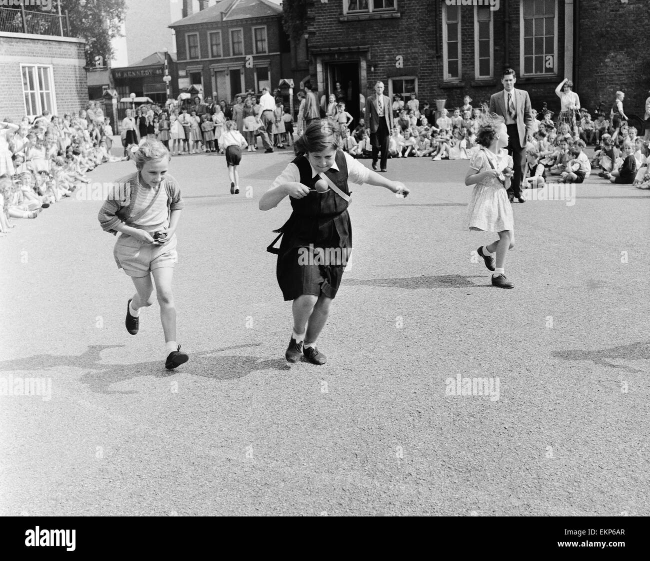 Girls of Oliver Goldsmith Junior School in Peckham London take part in the egg and spoon race during the School sports day. 25th July 1955. Stock Photo
