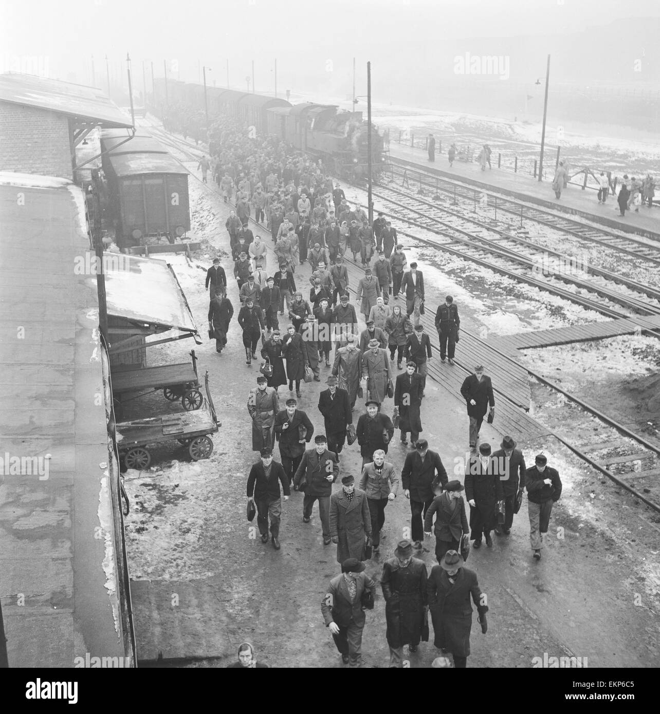 Workers seen here making their way to the Volkswagen factory at Wolfsburg from the railway station. 10th December 1952 Stock Photo