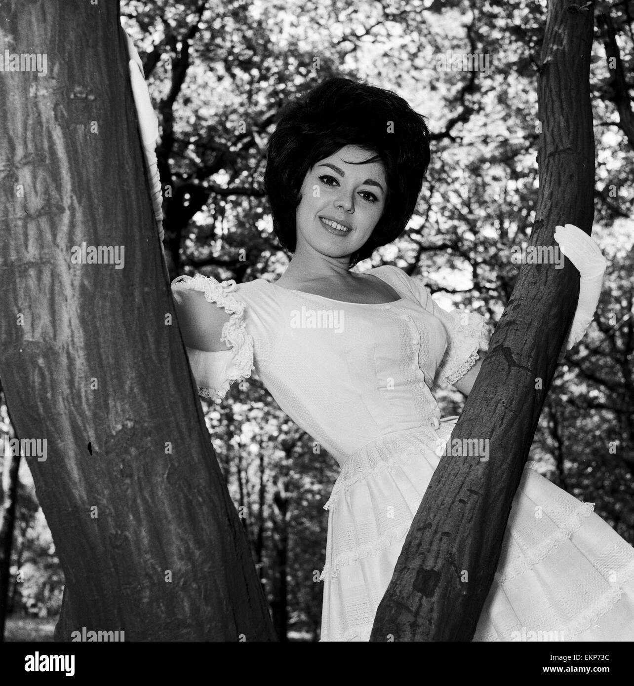 Actress and singer Susan Maughan, aged 20, photographed in a park near her home in Hornsey, London wearing an Ascot styled hat and dress. 11th June 1963. Stock Photo