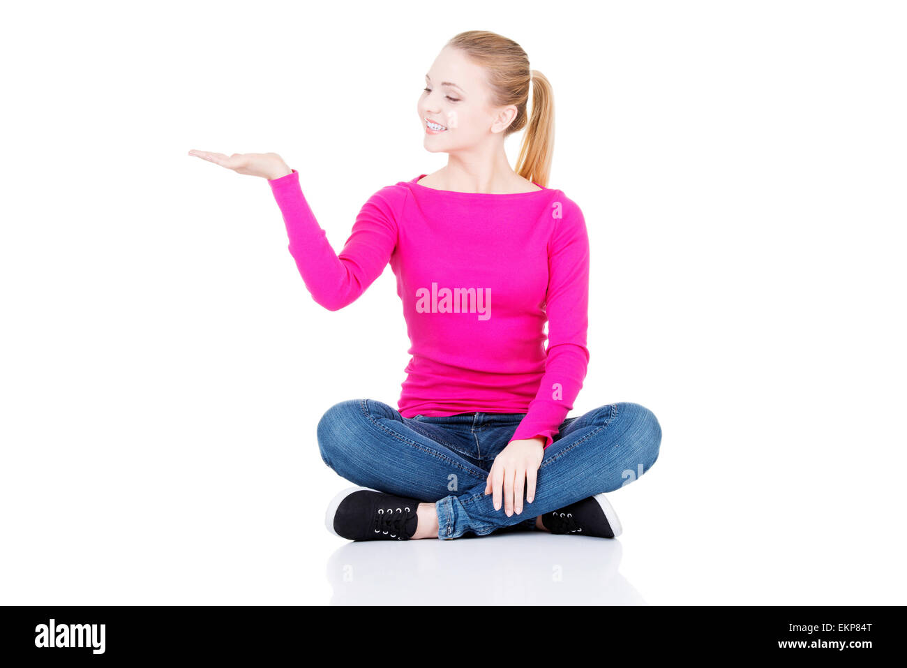 Excited young woman presenting copy space on her palm Stock Photo - Alamy