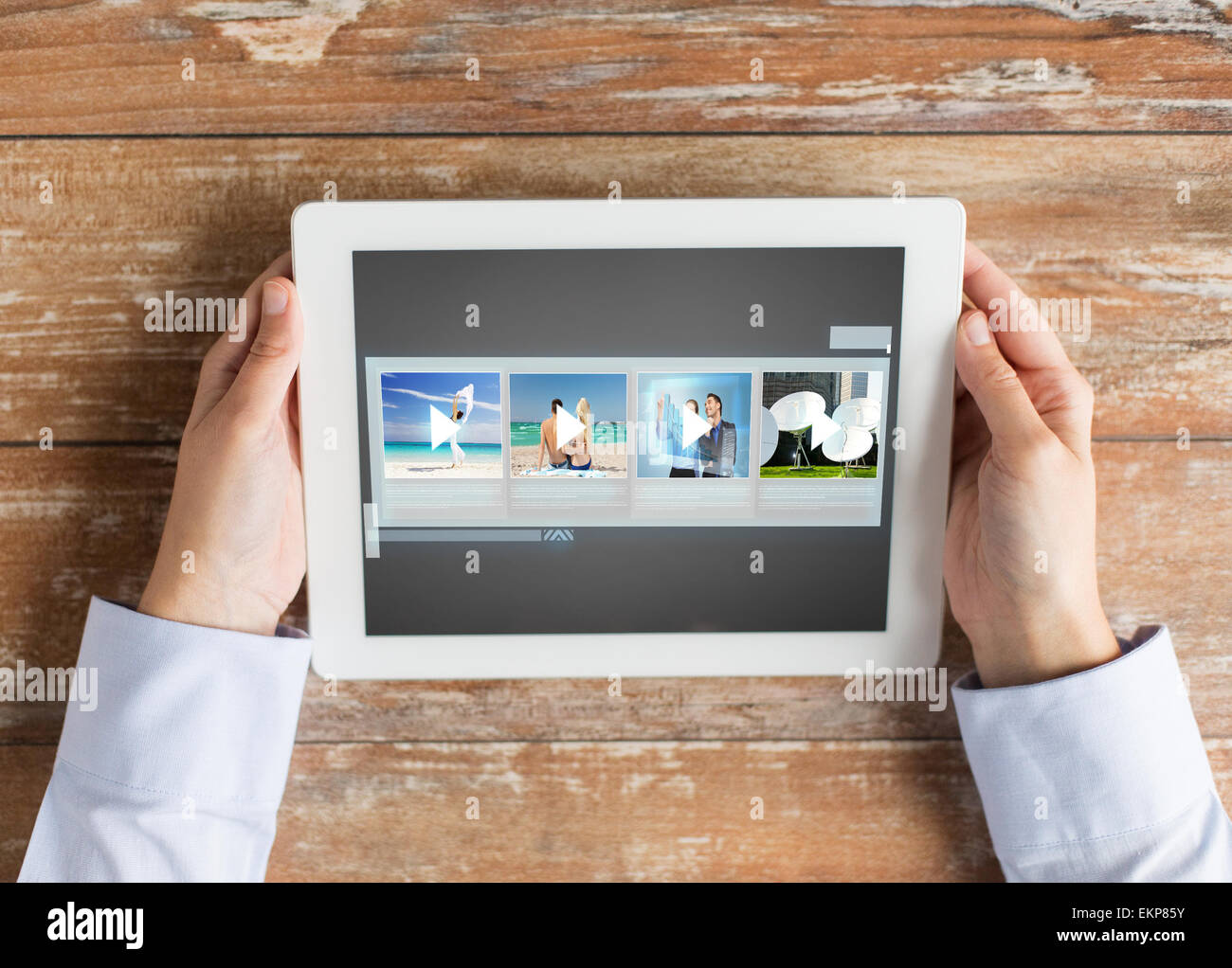 close up of hands with video gallery on tablet pc Stock Photo
