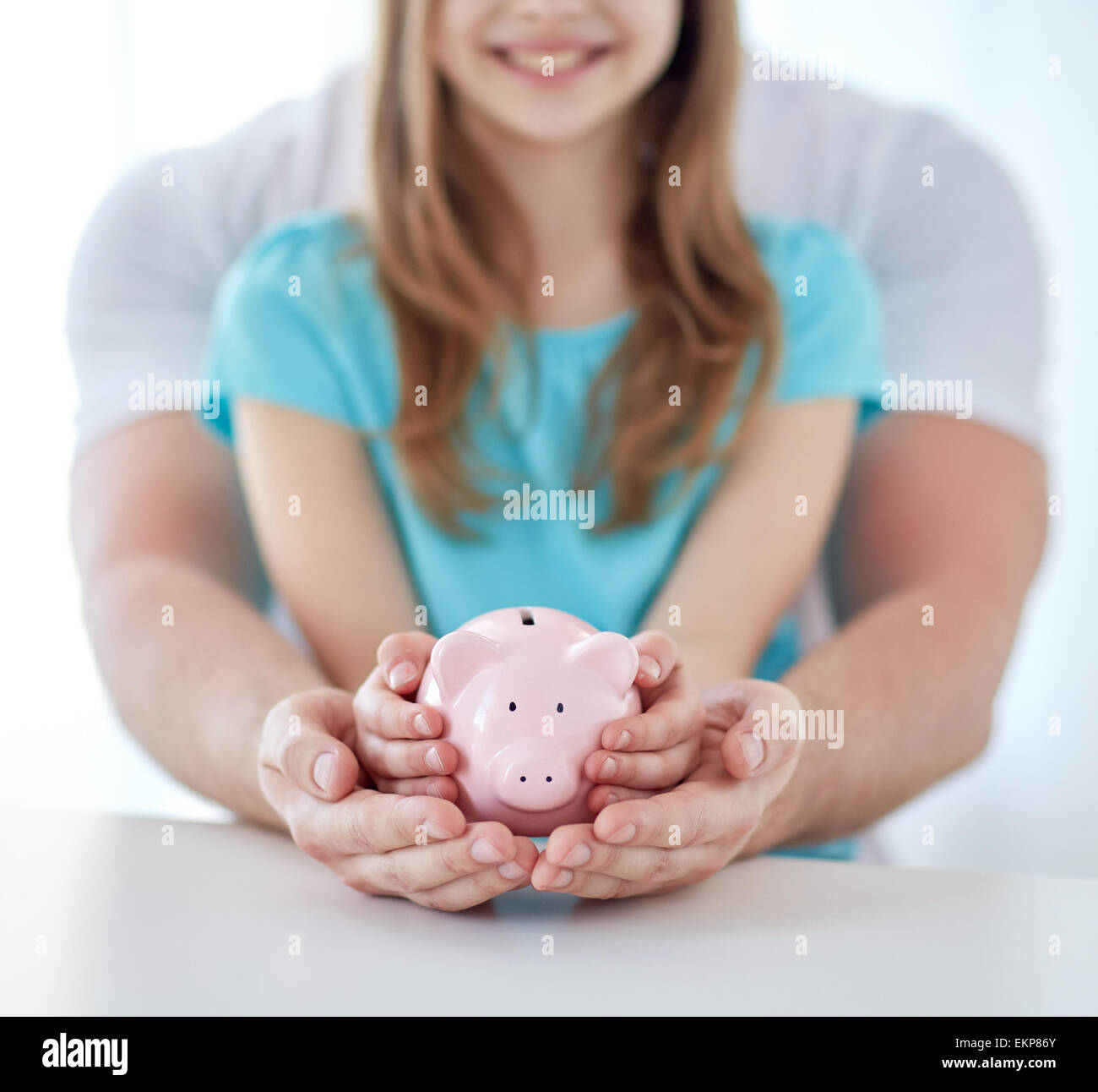 close up of family hands with piggy bank Stock Photo