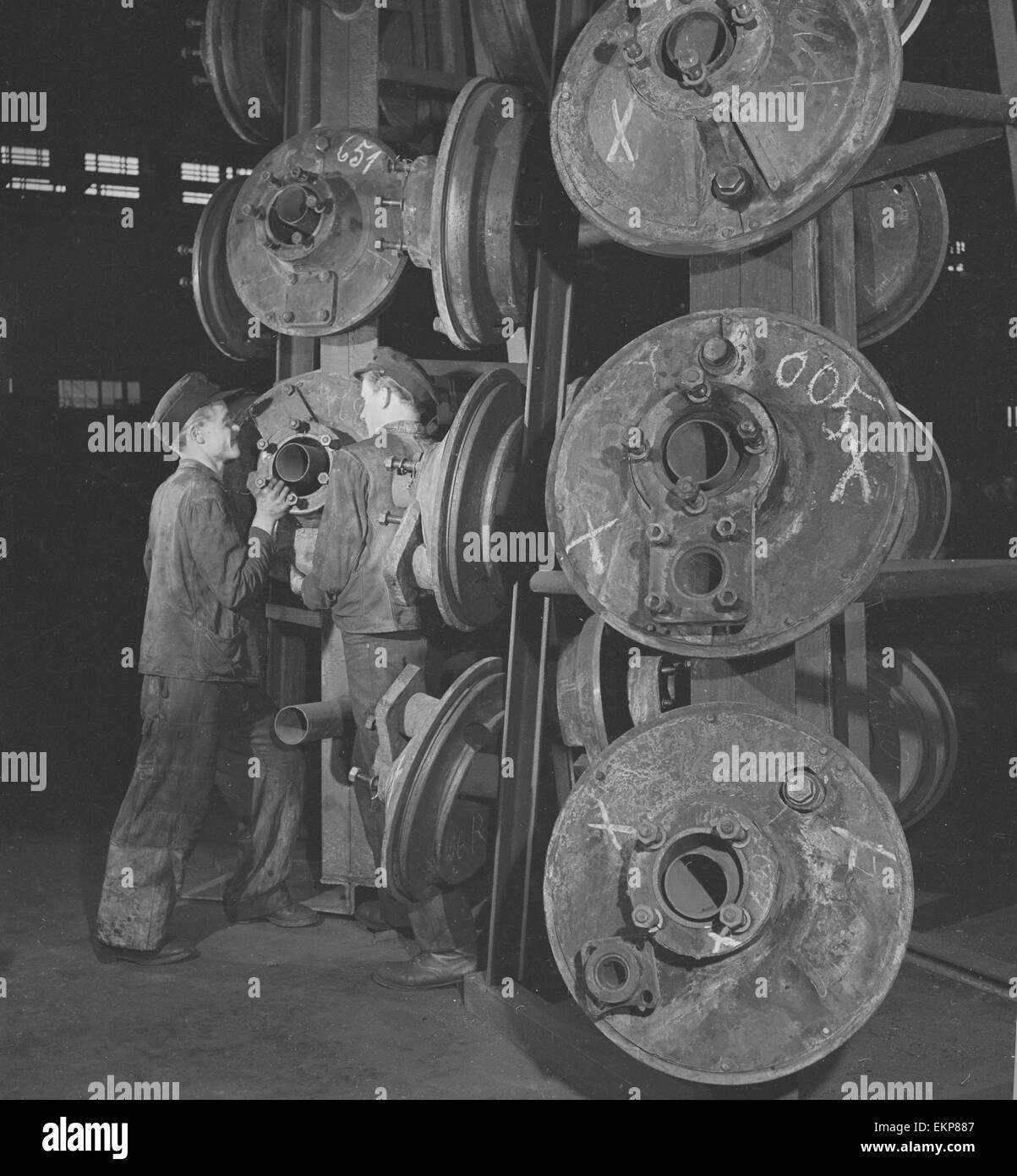 Engineers seen here selecting wheels at the Lowa Montages Fabrik Steam Locomotive repair facility in Essen, Germany. The factory formerly owned by Krupps employs 1,500 men and during the war this factory made tanks. Since June 1945 the factory has worked Stock Photo