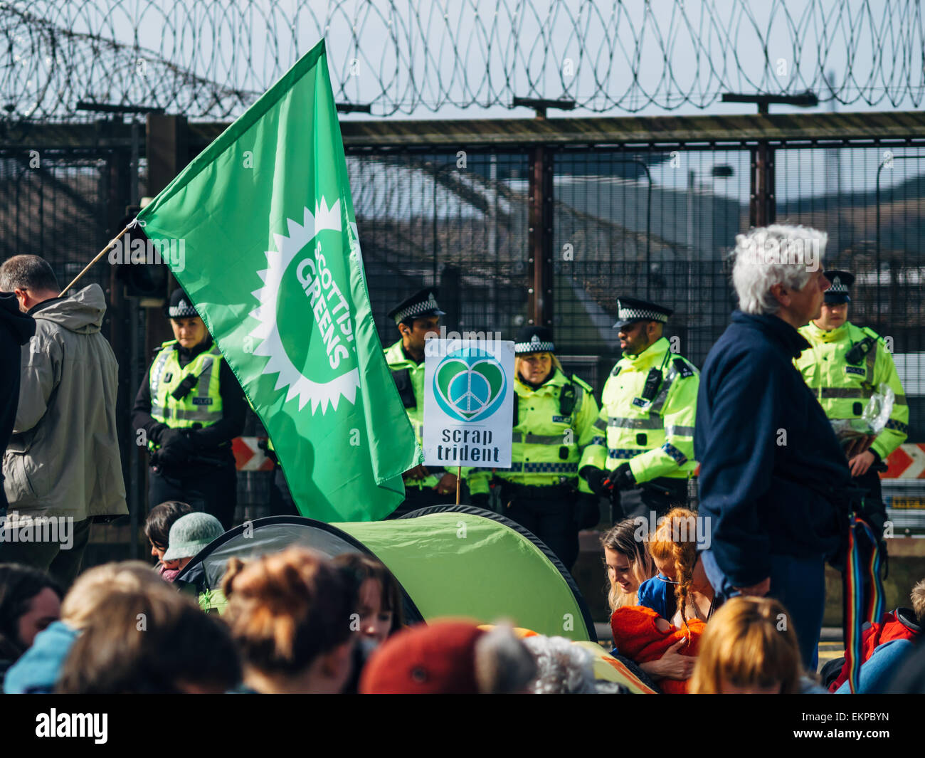 Glasgow, UK. 13th April, 2015. Protestors of all ages gather at Faslane Naval base in Glasgow to capmpaign against the Trident nuclear submarines based there, with the slogans 'Scrap Trident' & #BairnsNotBombs. Credit:  Alan Robertson/Alamy Live News Stock Photo