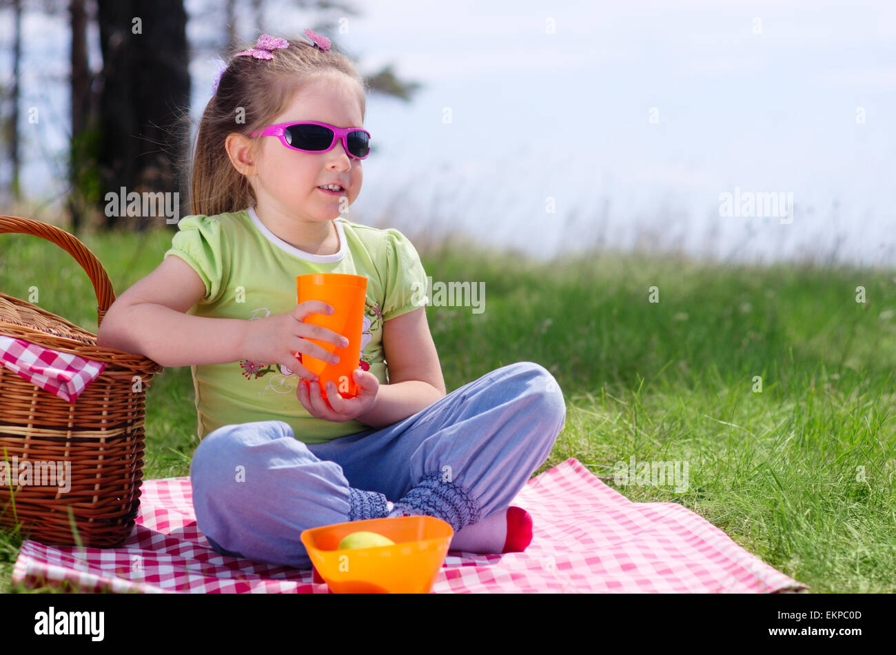Little girl with picnic basket and plastic cup Stock Photo Alamy