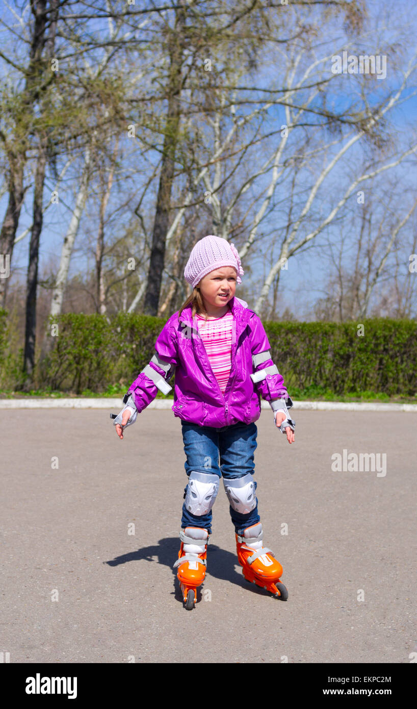 Little girl rides roller skates Stock Photo Alamy
