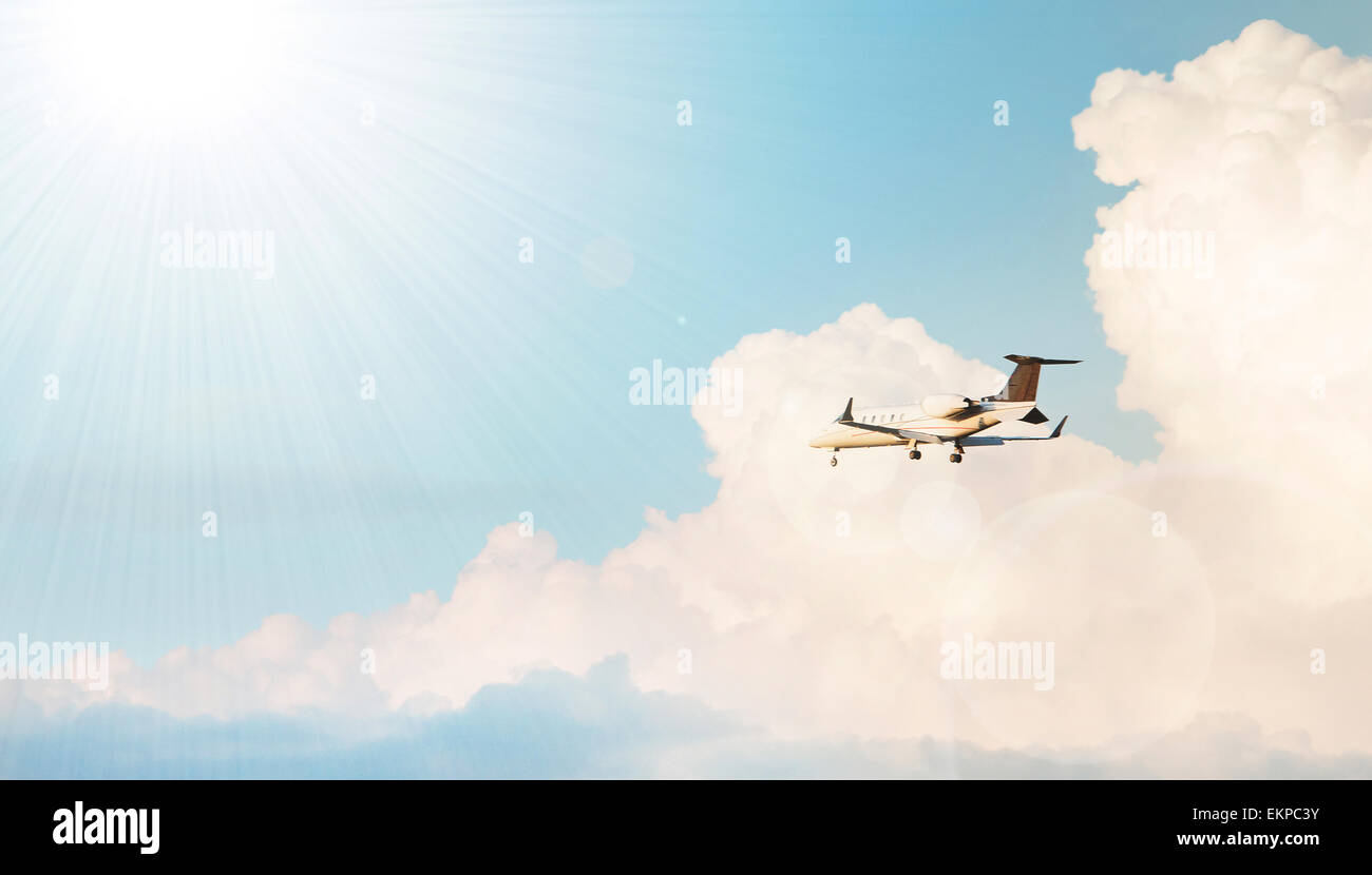 Airplane flying in a cloudy sky Stock Photo - Alamy