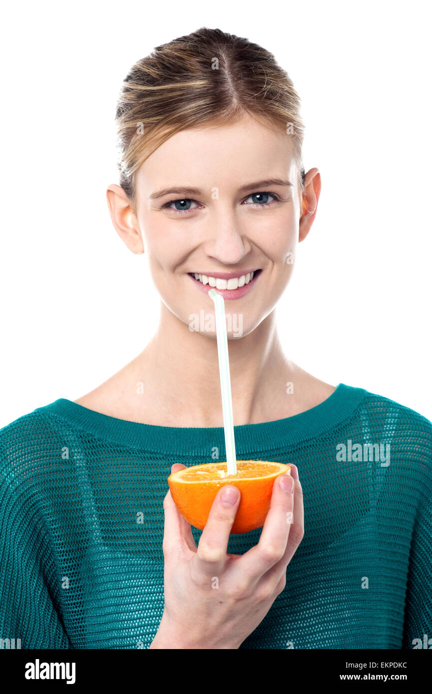 Girl sipping orange juice through straw Stock Photo Alamy