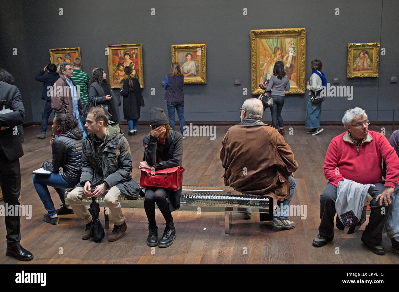 A sulking daughter hides from the camera at the musee d'orsay in Paris, France Stock Photo