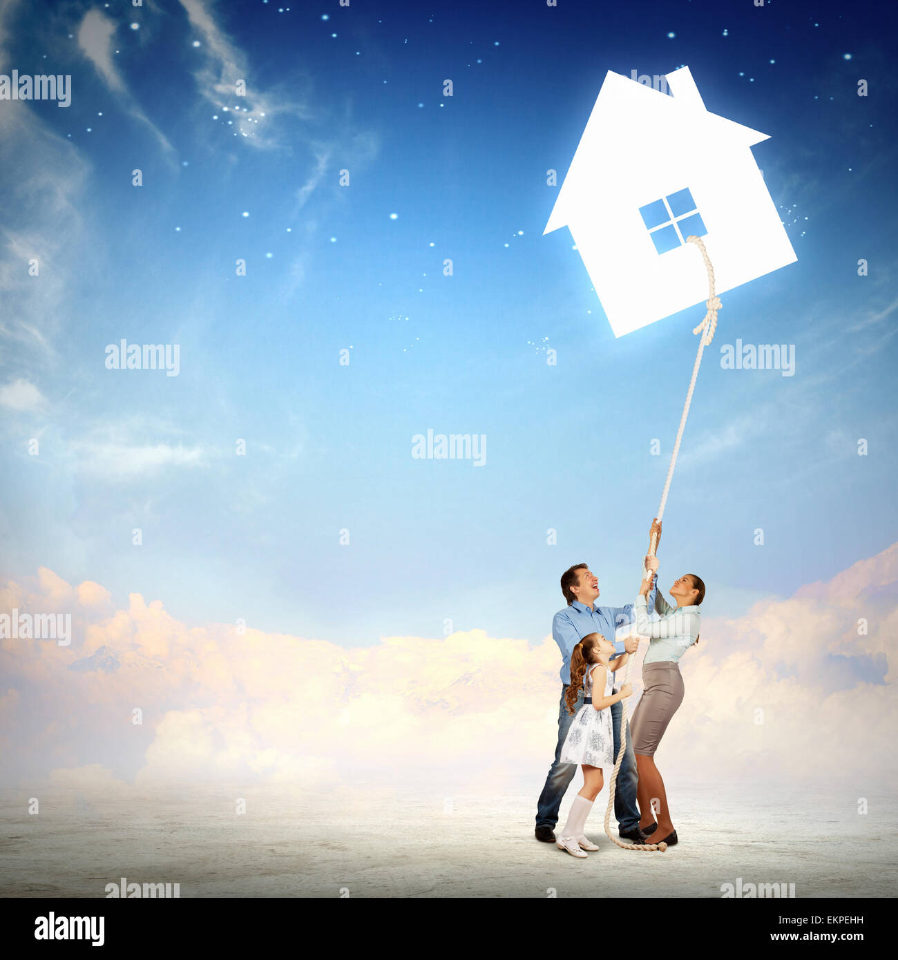Family pulling rope with a symbol of house Stock Photo - Alamy