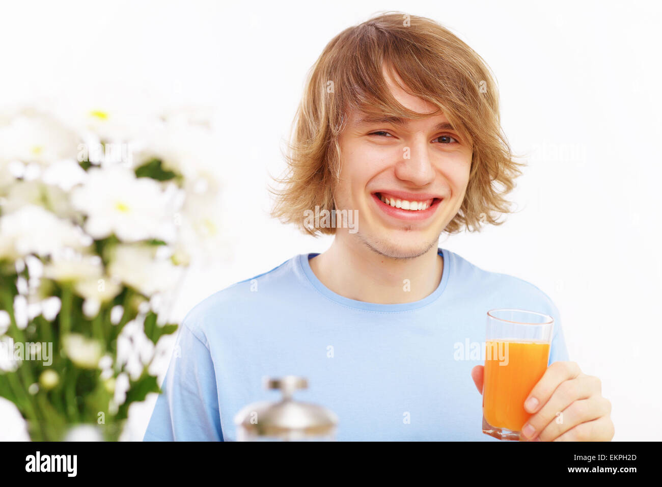 Young man drinking juice Stock Photo Alamy