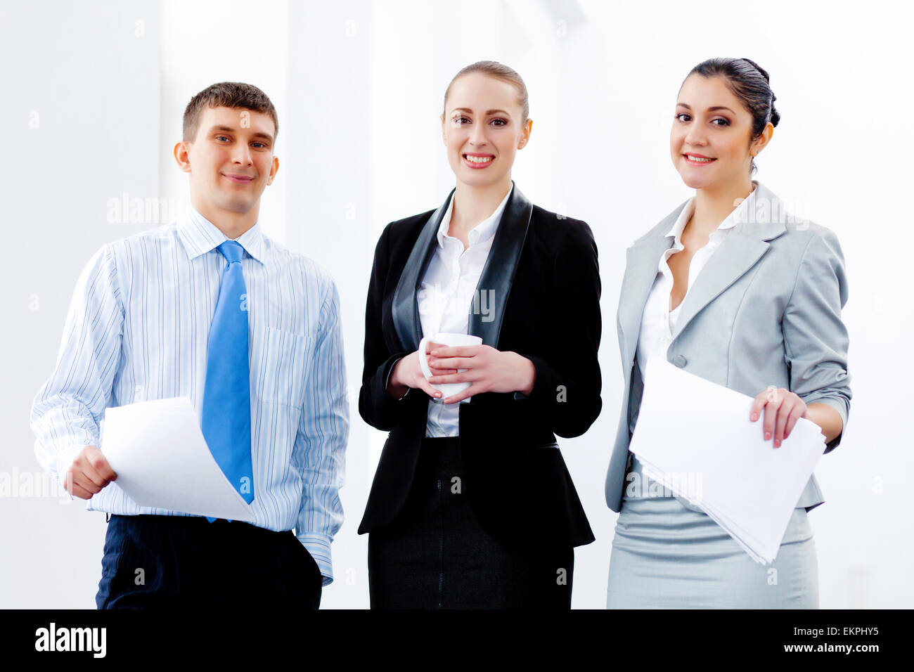 Three young business people laughing Stock Photo - Alamy