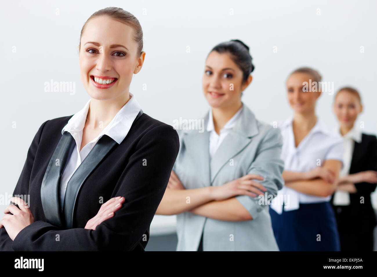 Four businesswomen standing in row Stock Photo - Alamy